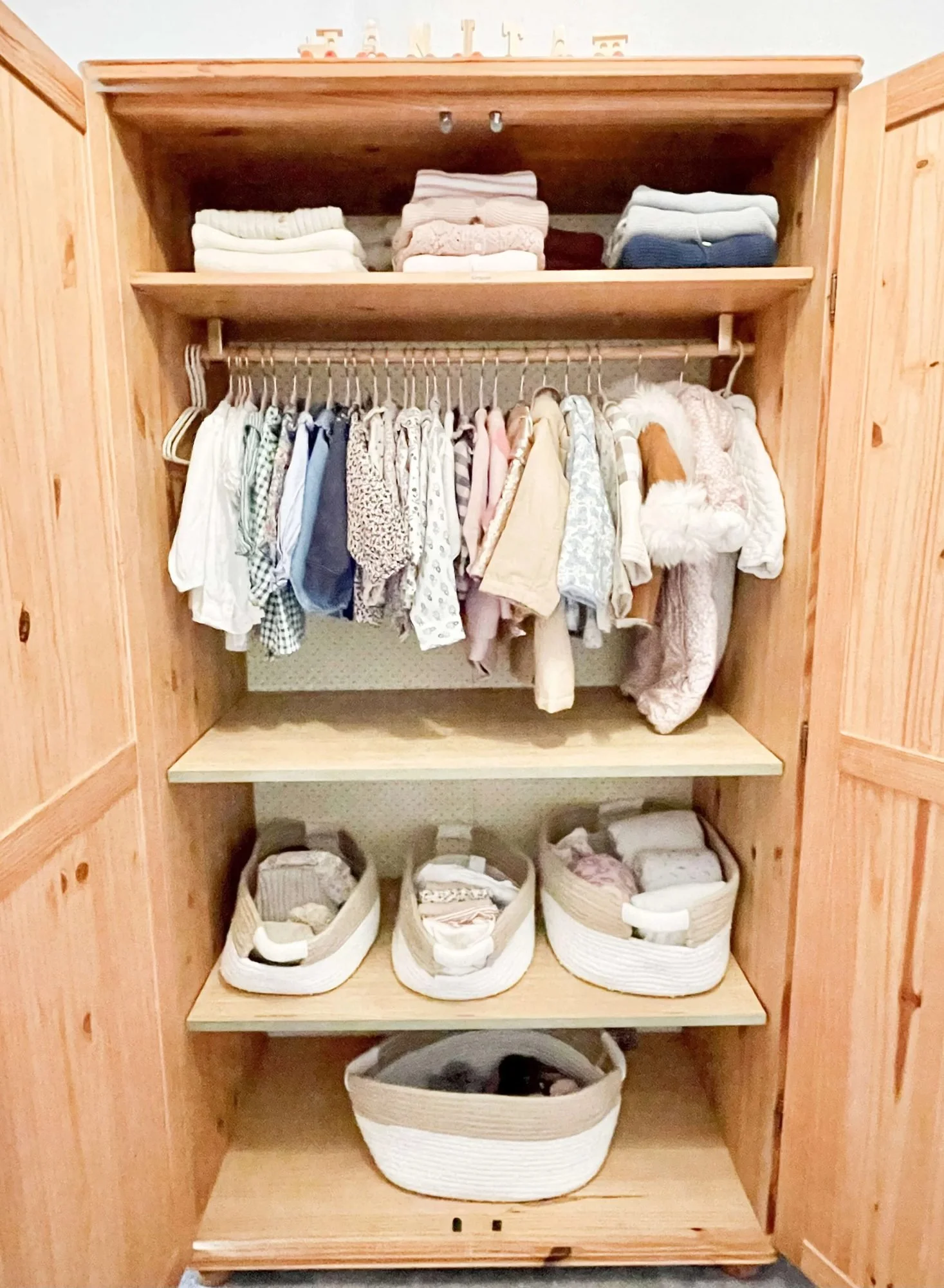 Child's wardrobe organised with hanging and file folding