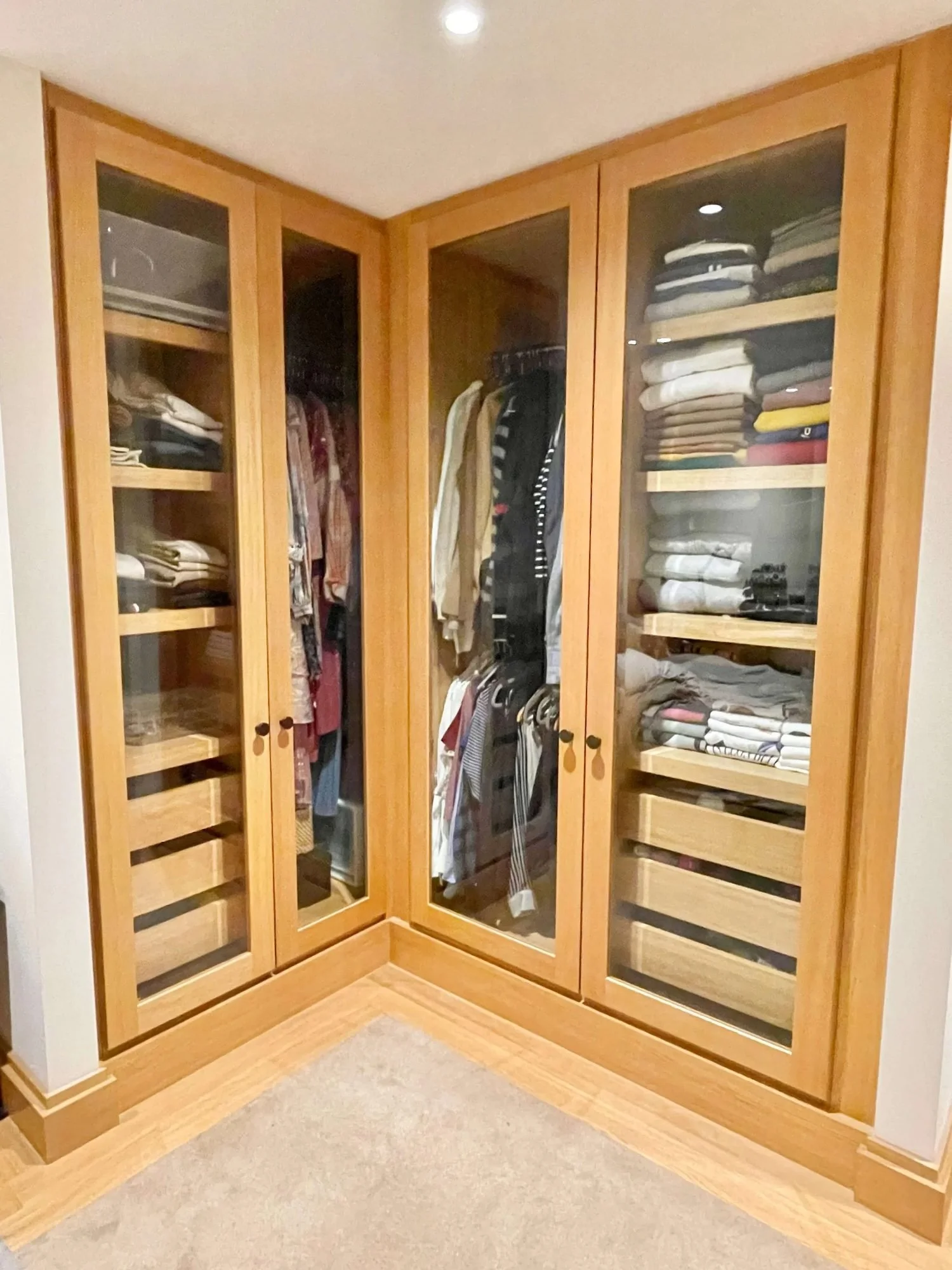 Walk-in wardrobe with clothes hung and file folded