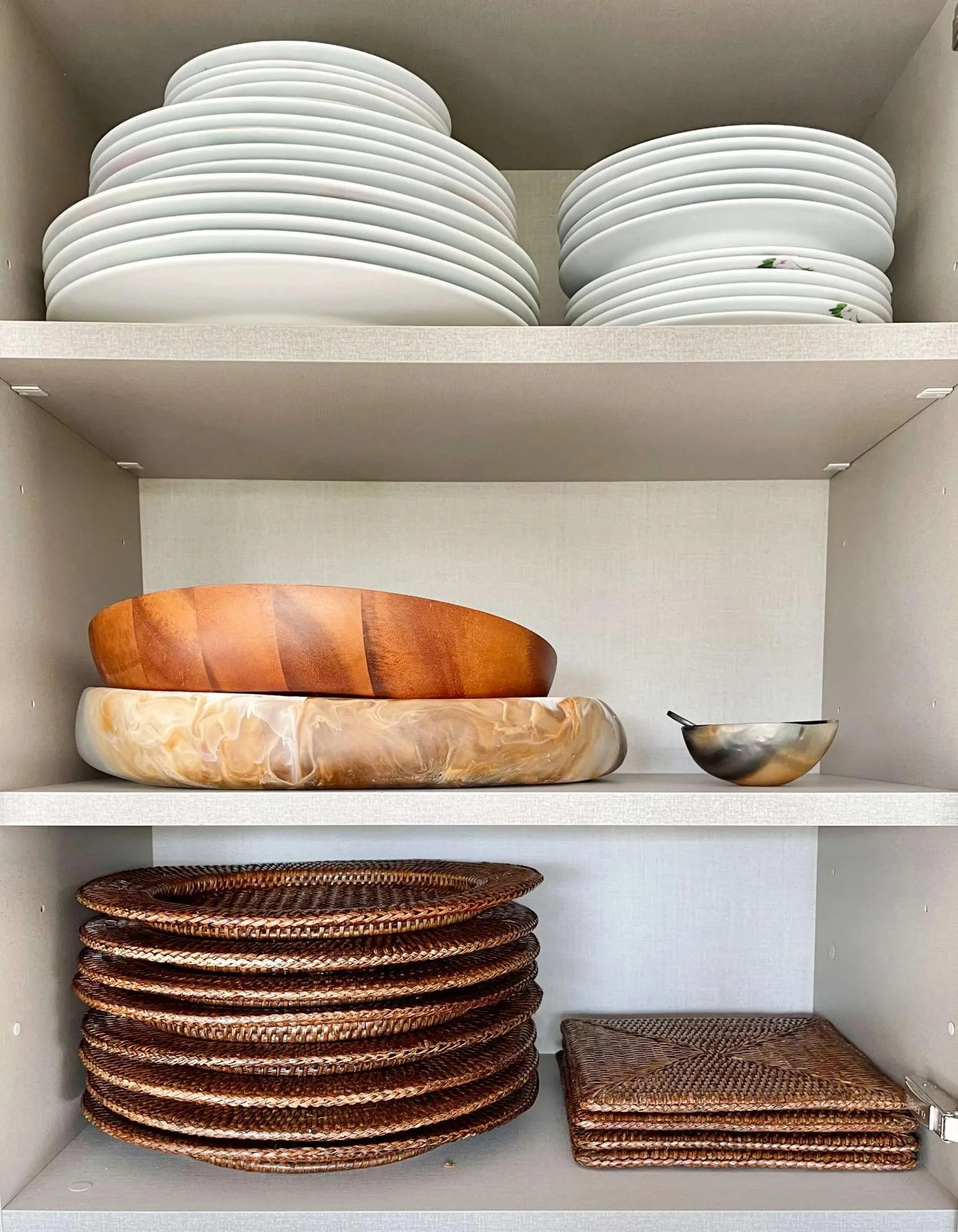 Dishes arranged neatly and by type in a kitchen cabinet
