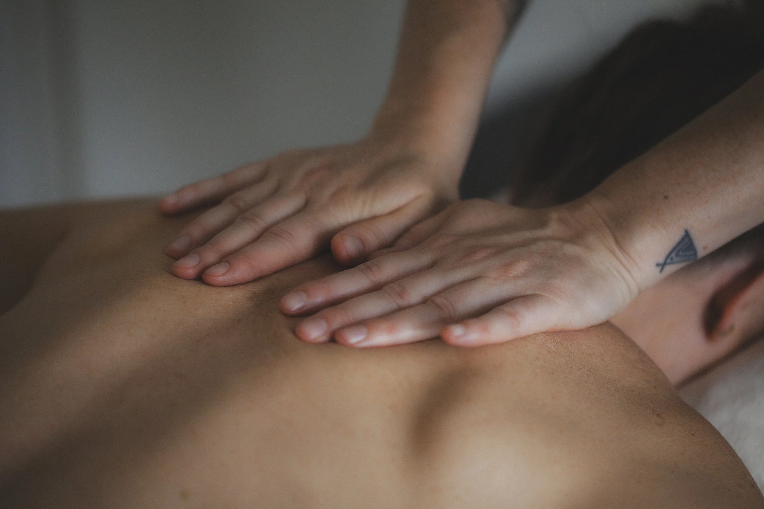Hands laid flat on back