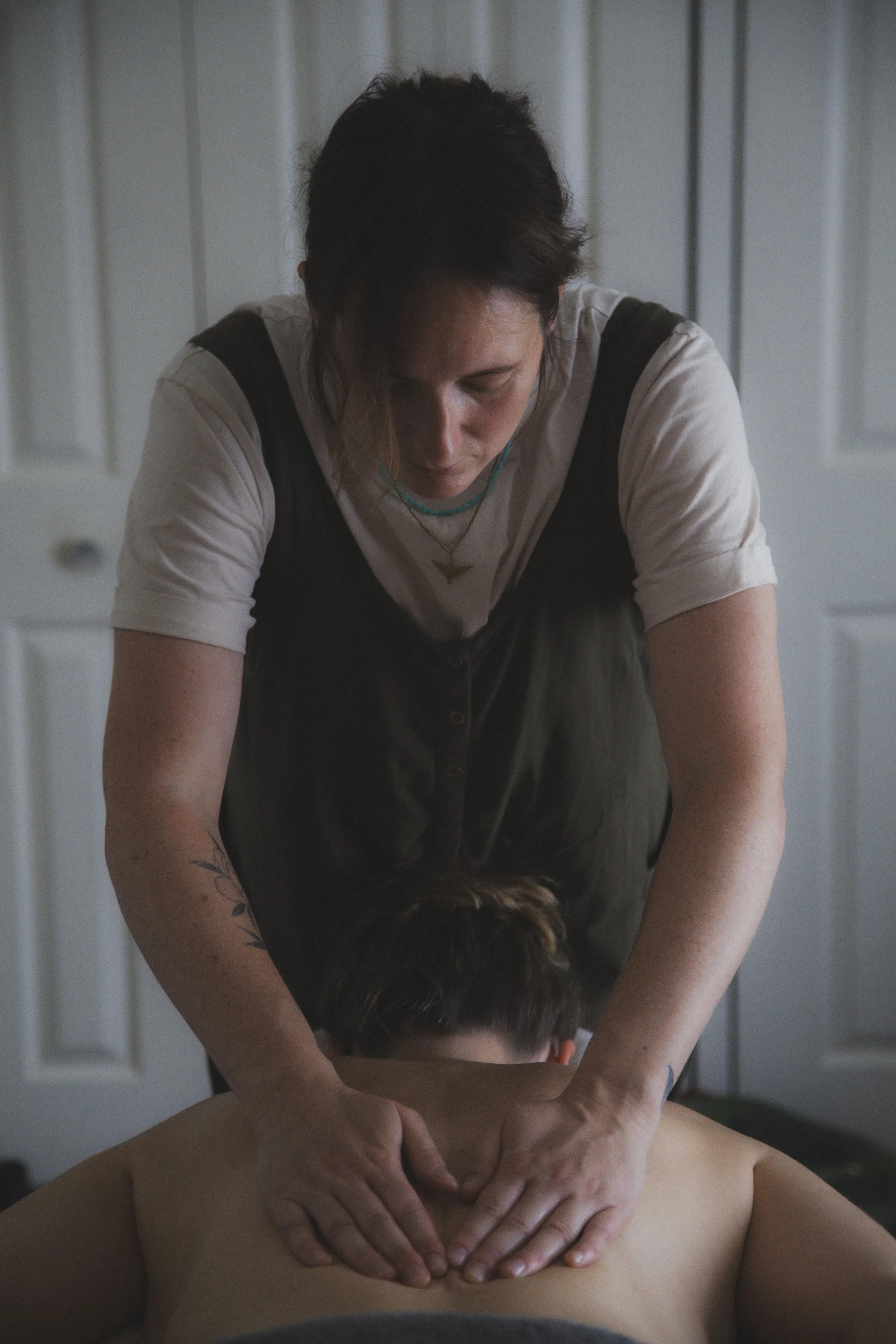 image of massage therapist with hands on client's back