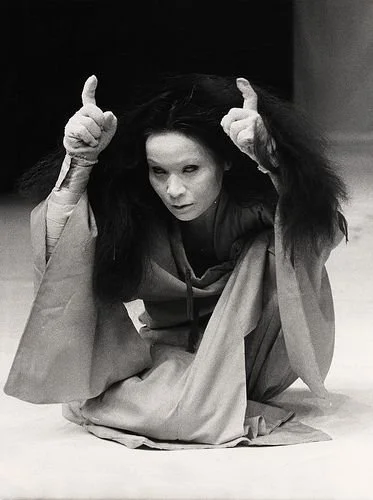 Carlotta Ikeda. Crouching. Gloves.