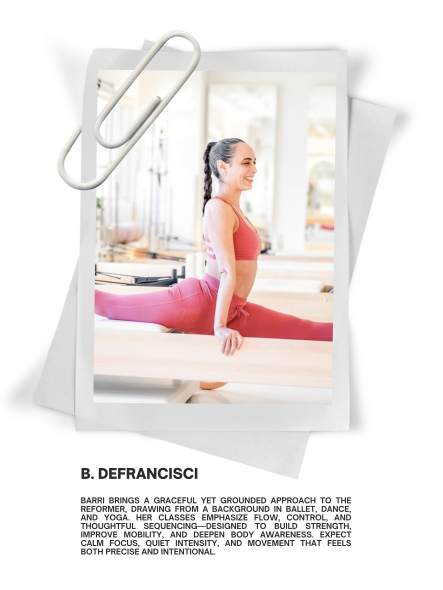 Smiling woman in pink athletic wear performing a split stretch on a yoga mat in a Pilates studio.