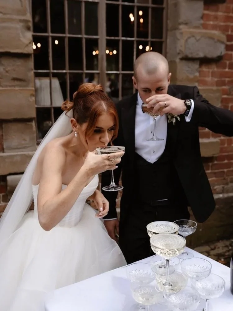Champagne towers &amp; just-married energy 🥂🍾🤍 

 @coachhouseatsoughton @soughton_hall 
@perfect_day_production - video 
@einirpg flowers and decor
@alongcameevebridal @watters - dress 
@weddingtailsbylucy dog sitter 
@gemmabaxmua - makeup
@lsp_br