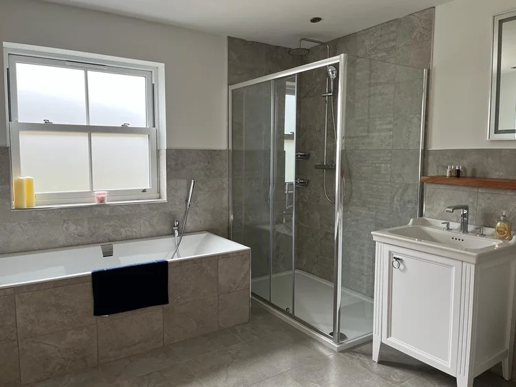 Foxhall Farm bathroom with bath and glass shower enclosure