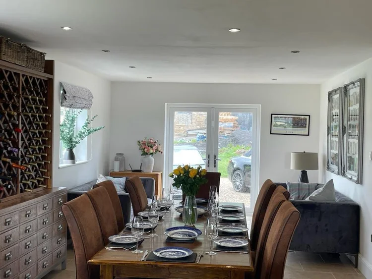 Foxhall Farm dining space with a long table and garden-facing doors
