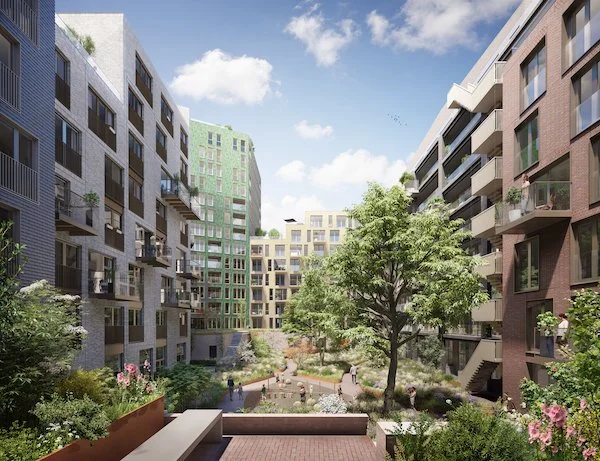 Modern residential apartment complex in East London with a landscaped courtyard, trees, plants, and walking paths under a blue sky with clouds.