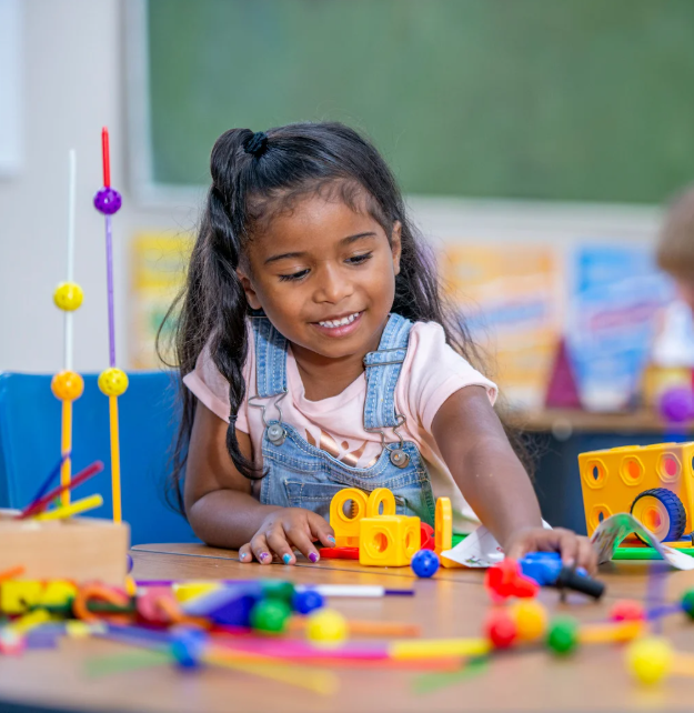 Girl building with toys