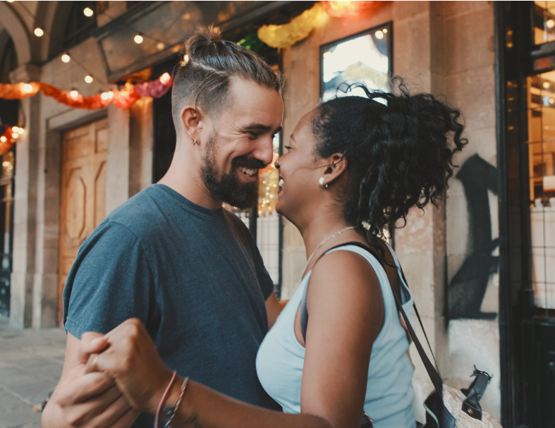 Interracial couple smiling at each other