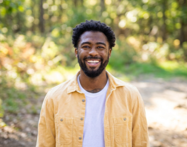 Smiling man outside in nature