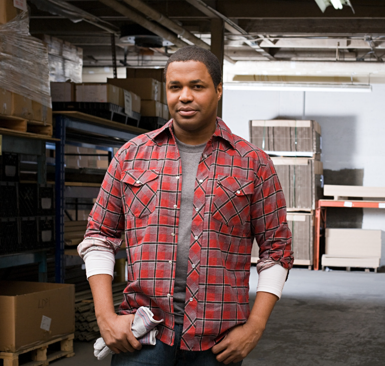 Black man standing in a warehouse