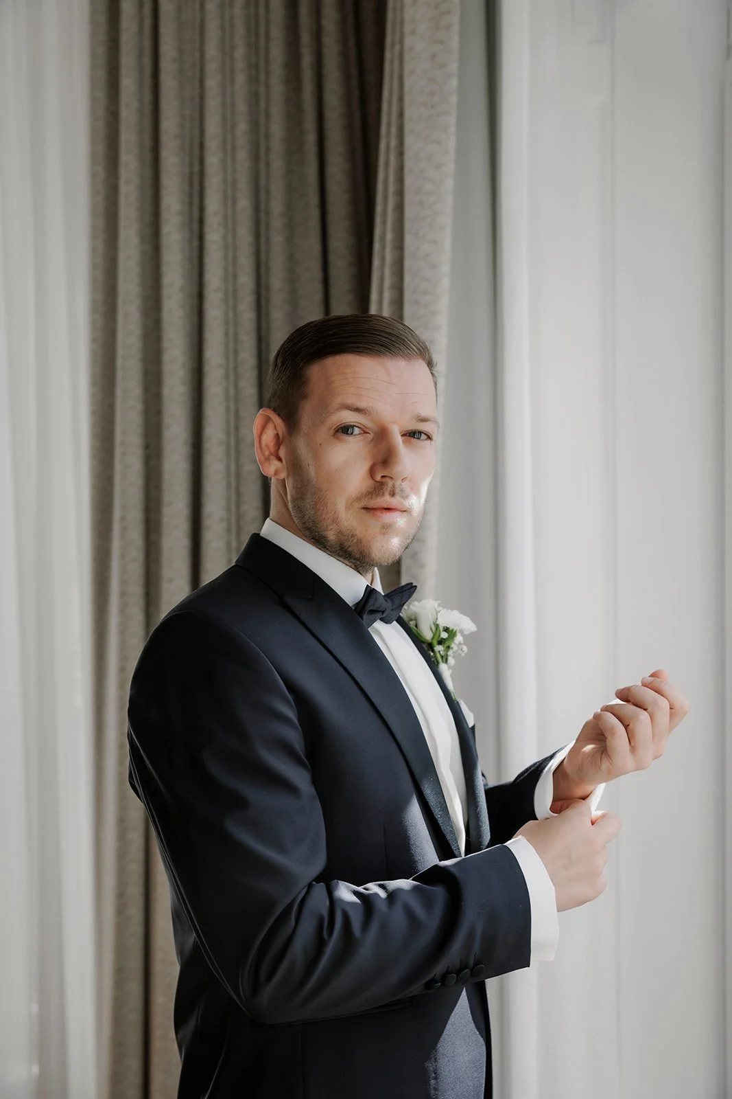 Handsome groom getting ready Austrian National Library wedding coordination Fine Events Vienna