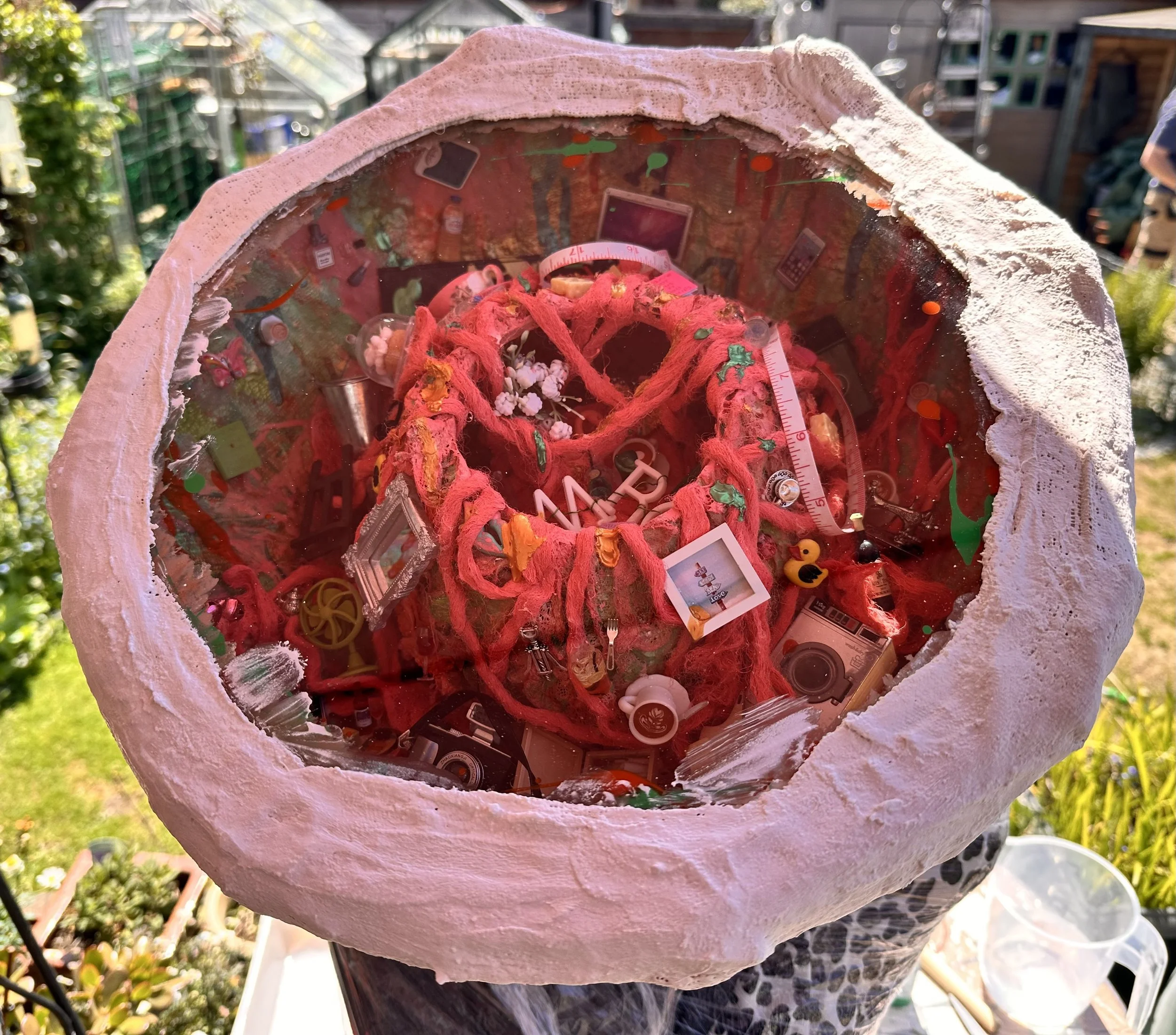 close up detail of the brain section of the meno brain sculpture with the glass top being put in position to protect the contents of the brain