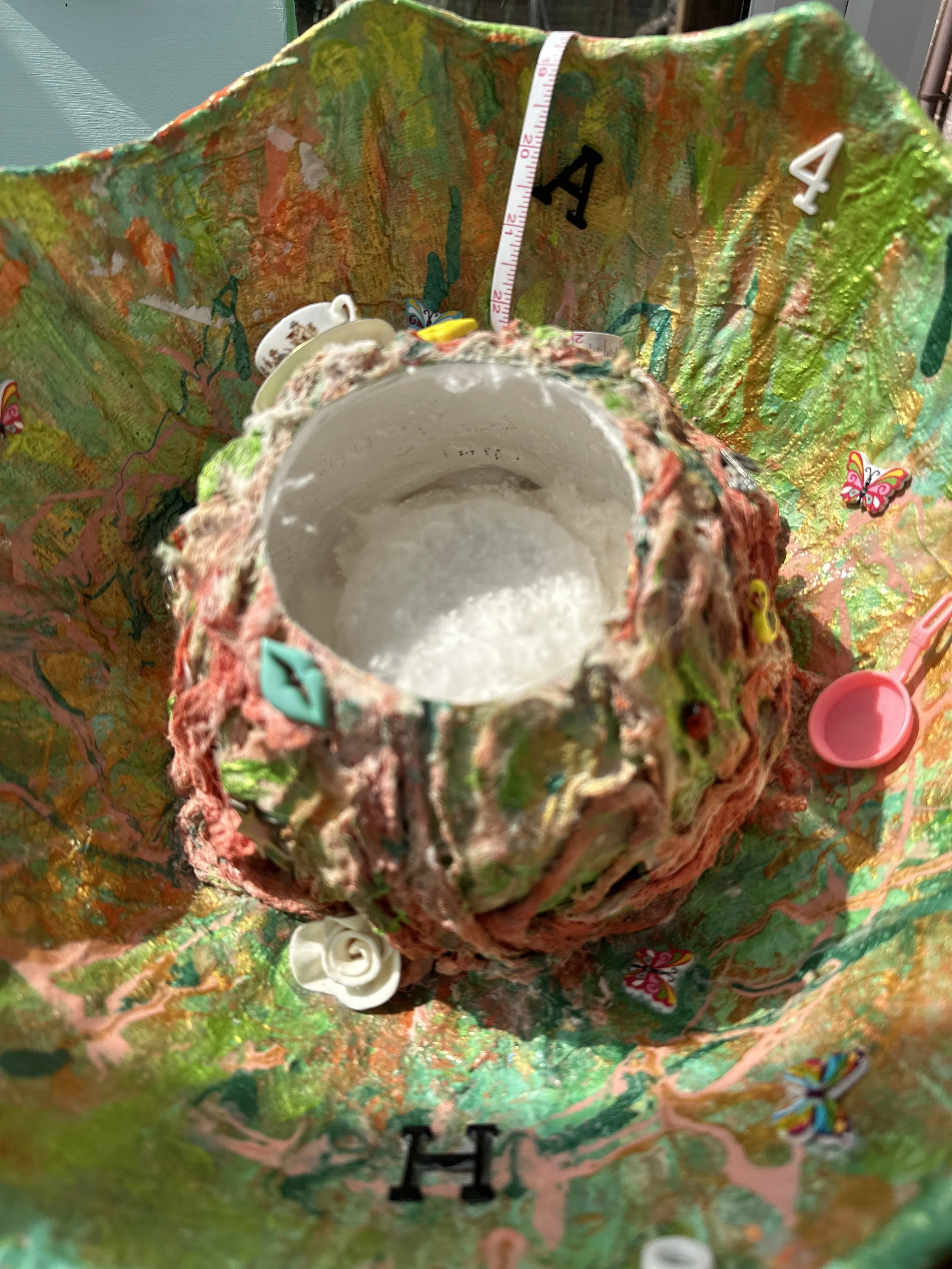 close up detail of the central brain section of the sculpture with the top having been cut off and painted white inside