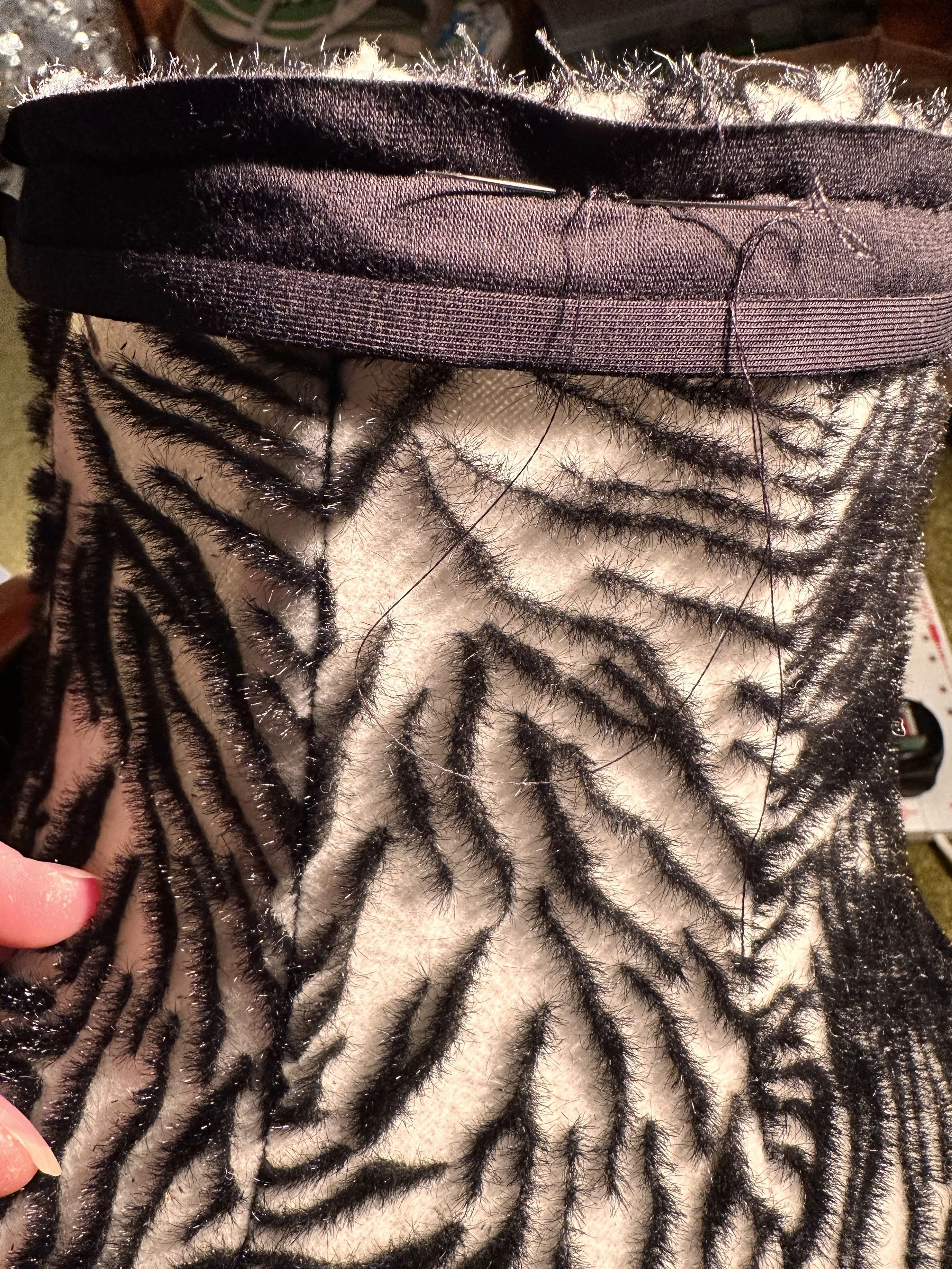 A close-up of the zebra fabric and hand-stitching along the lampshade’s top edge reading to be placed on the top of the boudicca lamp