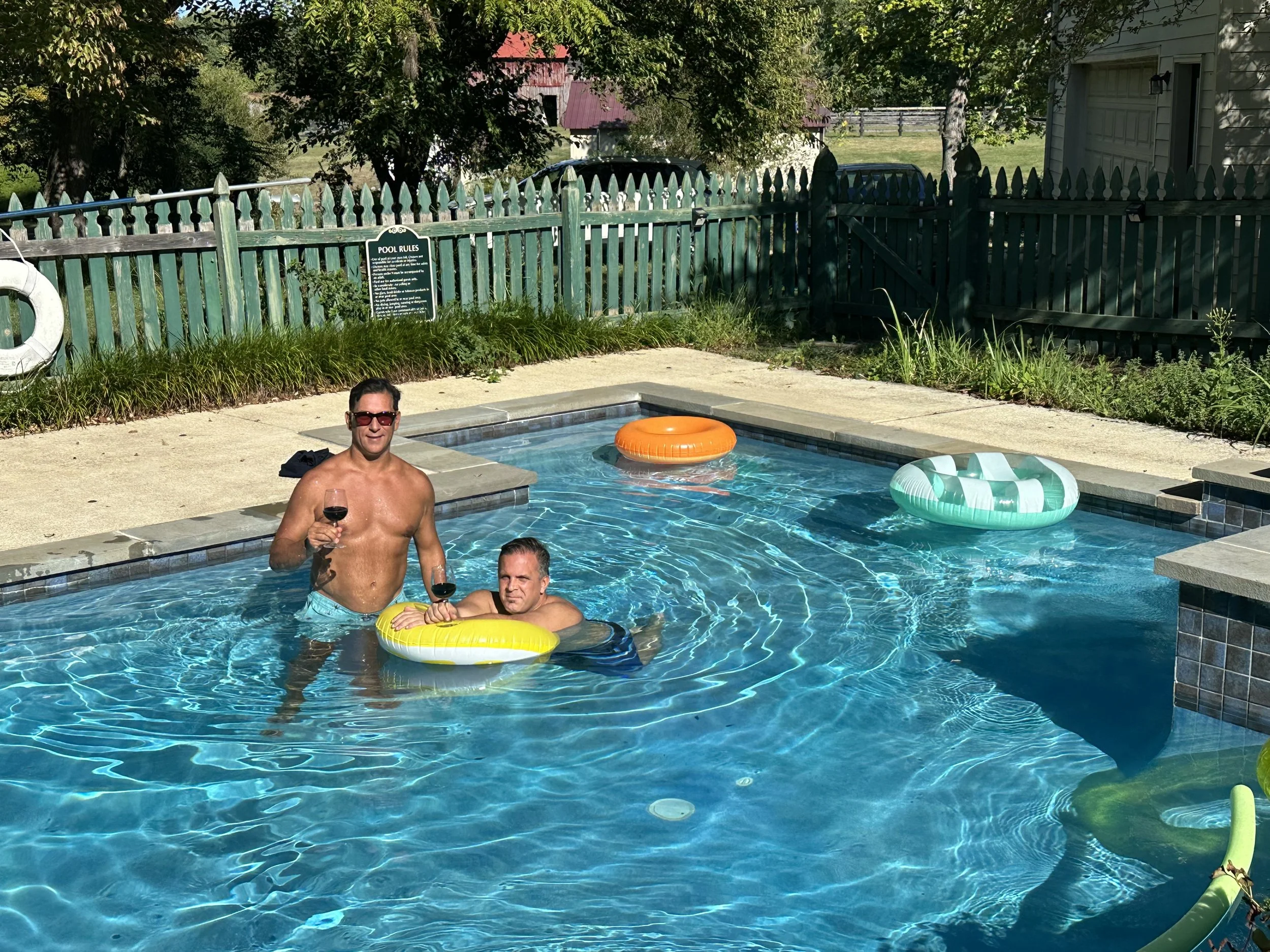 Father and child playing in the saltwater pool with floats at Barbee's X-ing