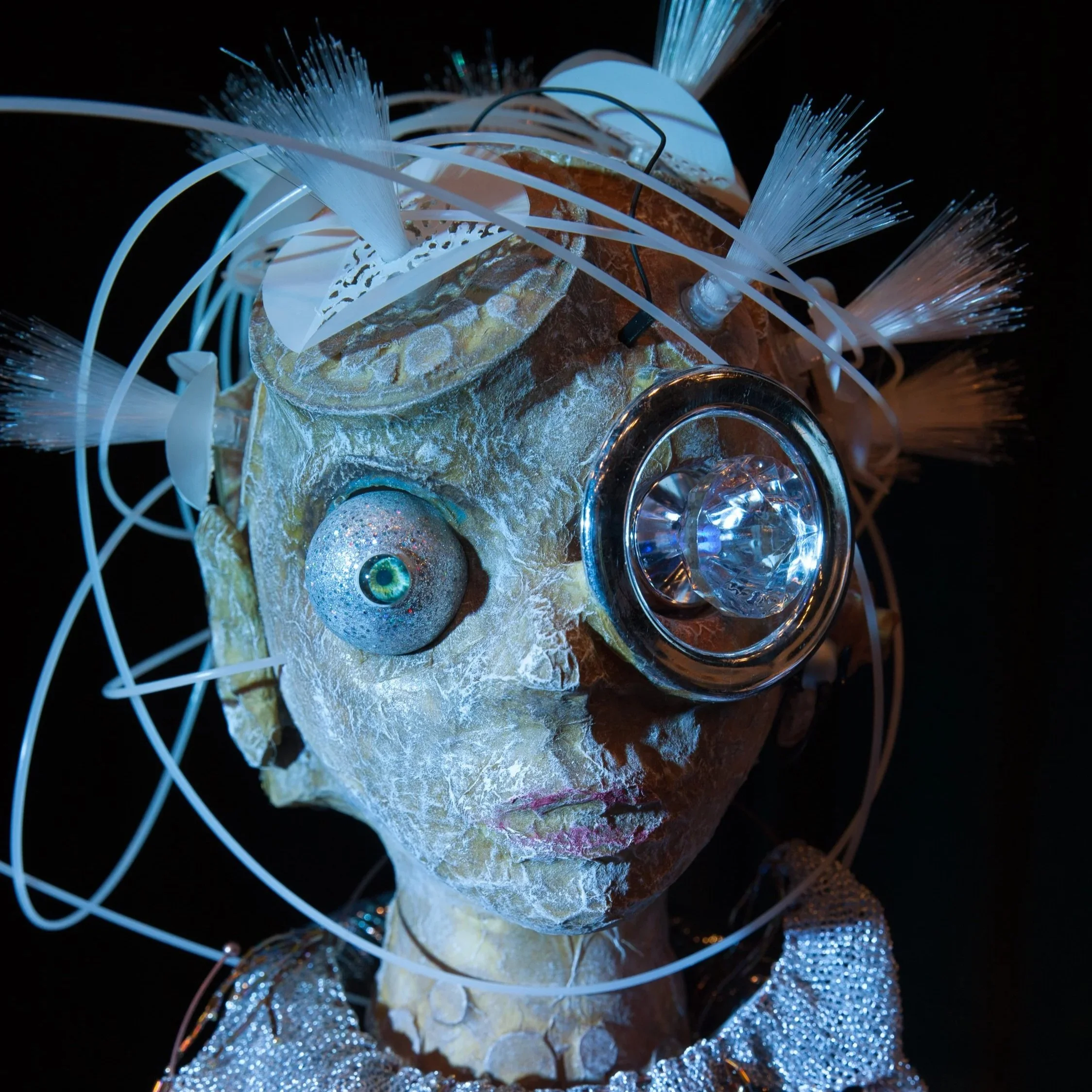 cyborg puppet with fiber optic hair and bulging eyes 