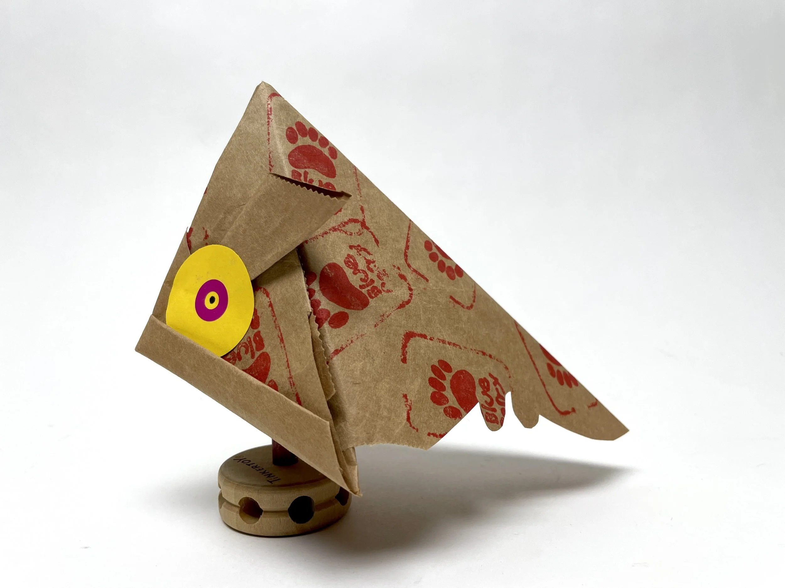 Folded Fish from brown paper with big yellow eye
