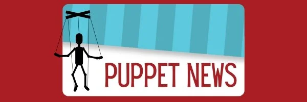 Puppet on strings hanging above a sign that reads 'Puppet News' with a red background.