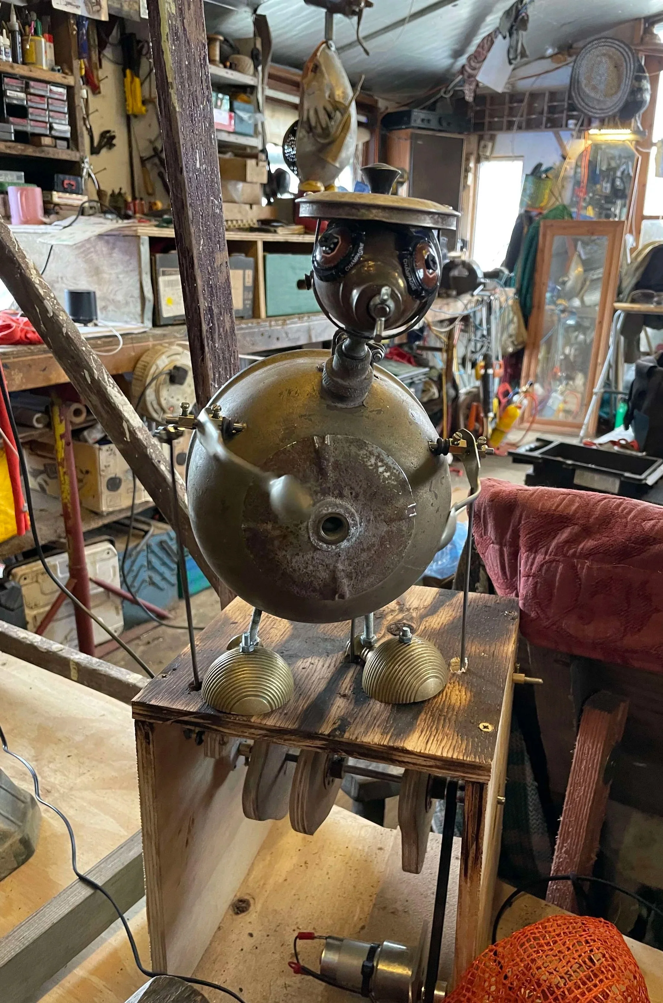 Mechanical looking puppet in a crowded old workshop setting