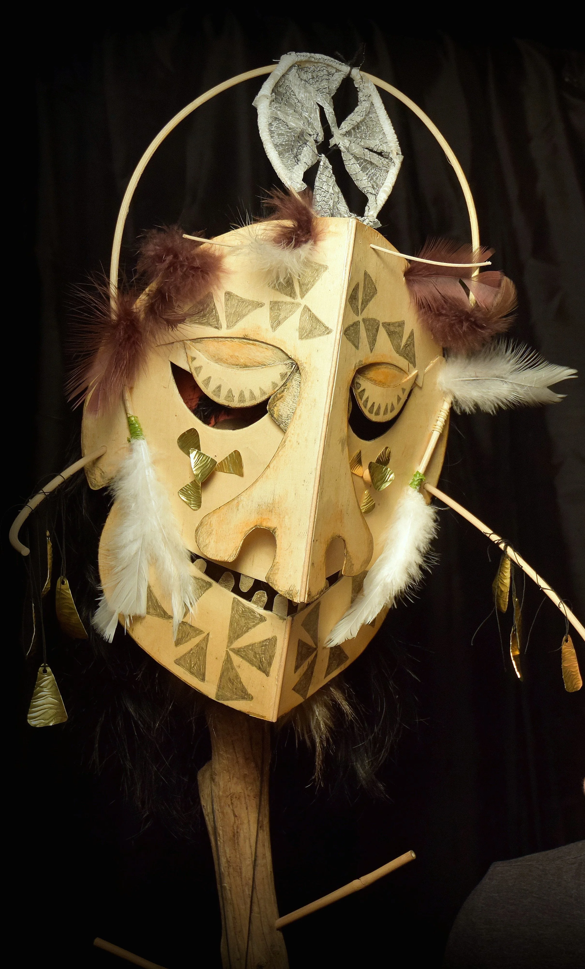 wood and feathered mask with pencil details