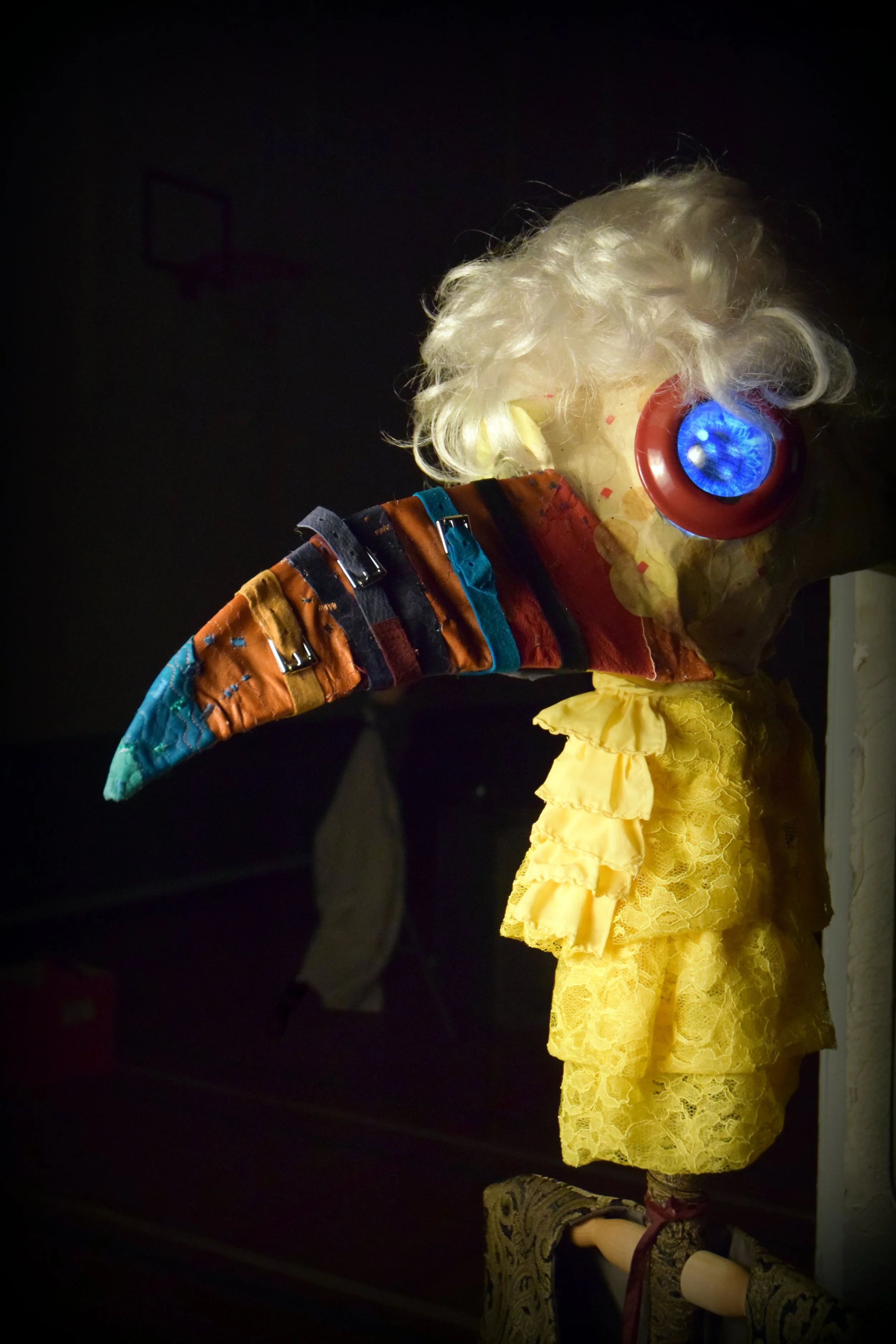 Yellow headed Puppet with a long beak like nose 