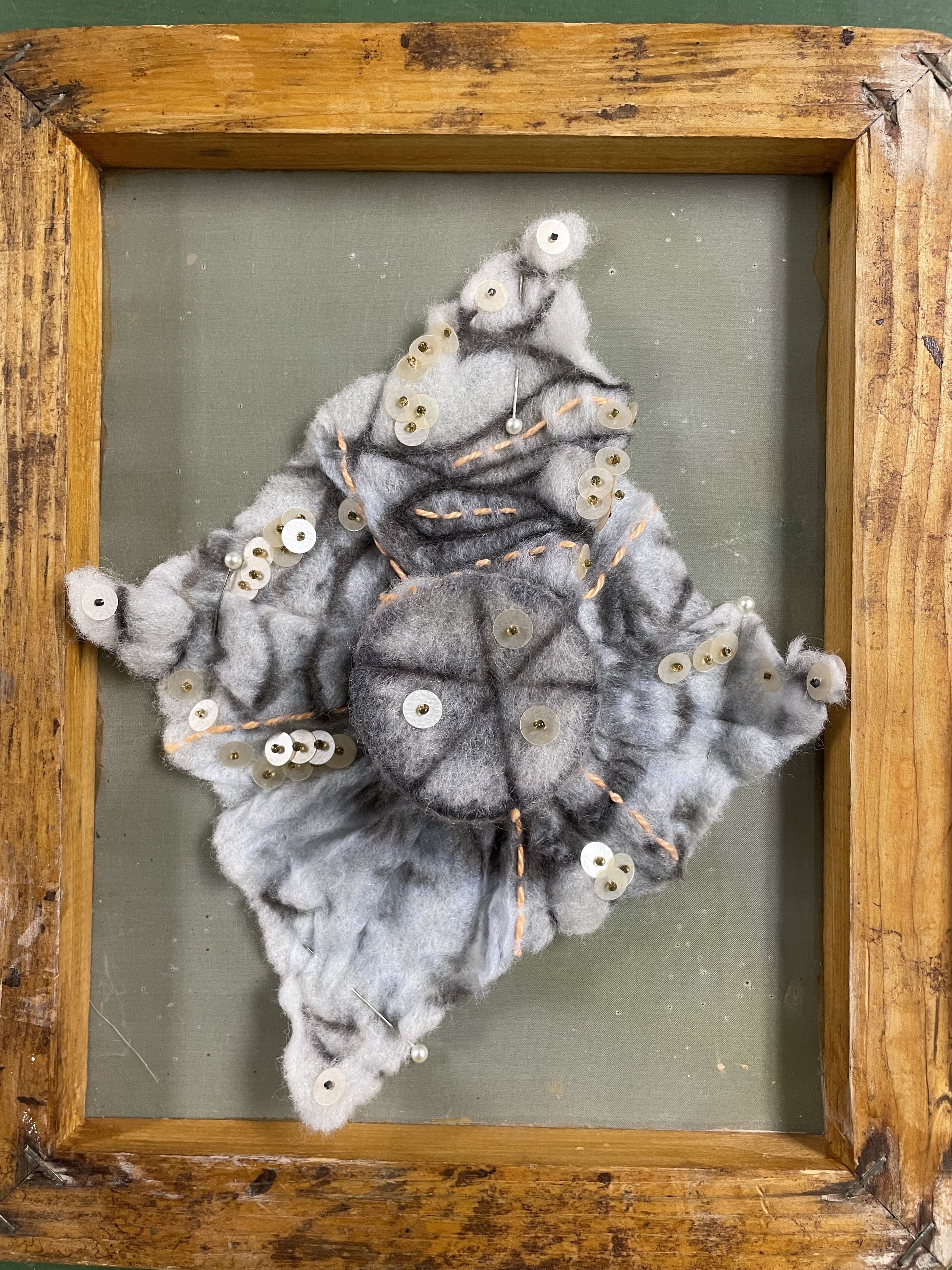 shibori felted shape stretched on a wood frame