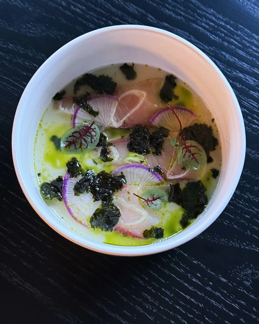 You are going to wanna try the current fish dish created by @chefasmith 
This Hamachi Crudo is cured in kombu and sake overnight, then served with a chilled, preserved lemon dashi made of its roasted bones, and it is 🔥🔥🔥
Book a seat this week! Lin