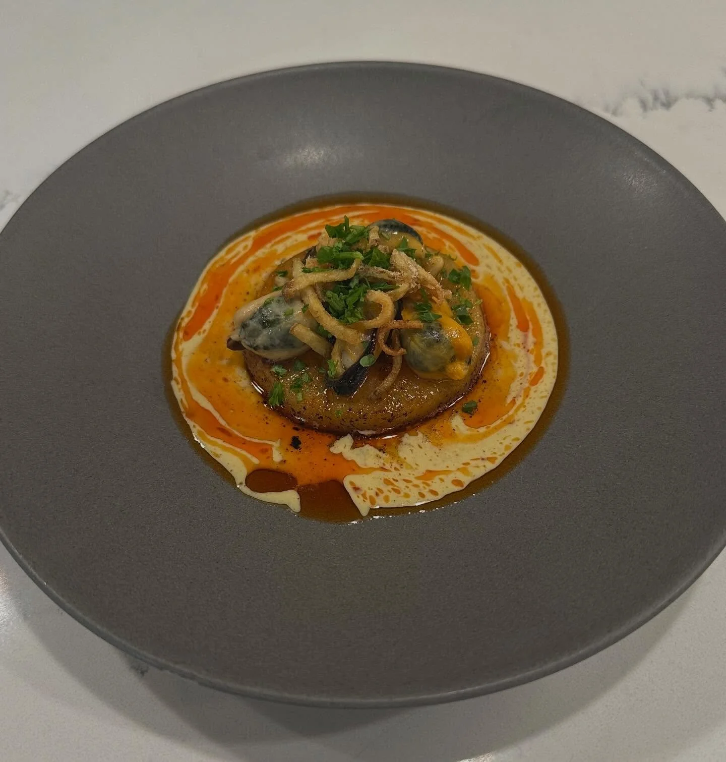 Rutabaga and mussels: Three Creeks farm rutabaga slow cooked in a curry chowder broth, butter poached mussels, salt and vinegar potato sticks and urfa oil.