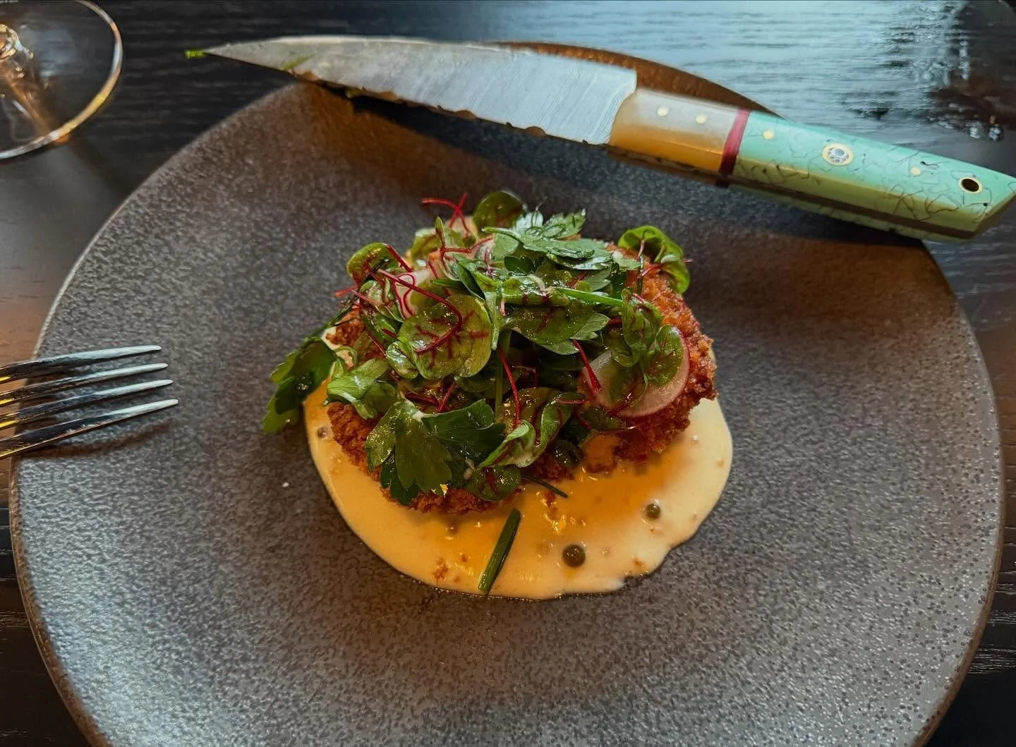 Behold! Our pork collar cutlet, currently on the menu.  It is seasoned overnight with rose garam masala and smoked black pepper.  Next it is breaded and fried. We then lay it over a sauce made of whole toasted coriander, whole braised mustard, whole 