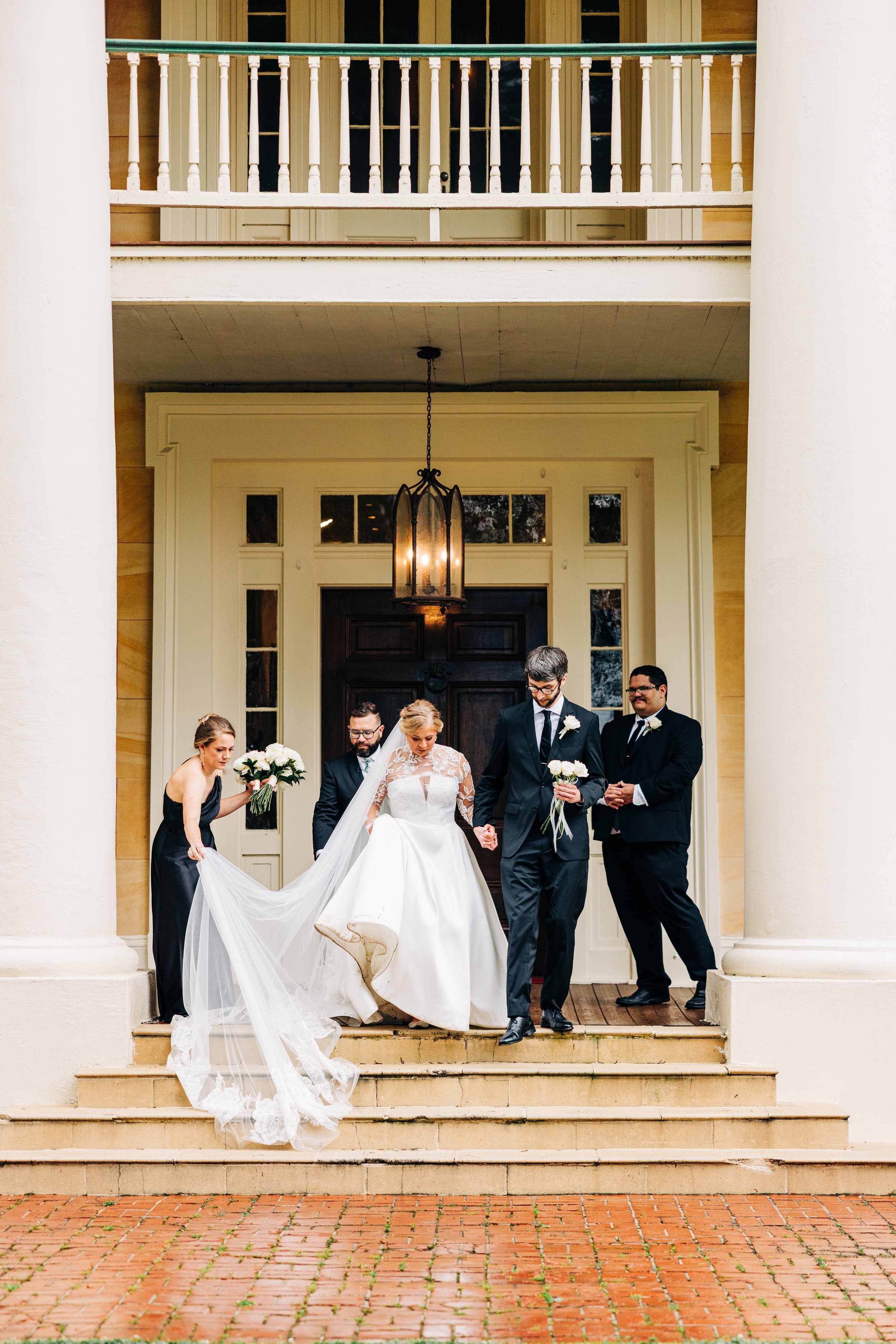 bride and groom on the front porch of houmas house during outdoor wedding ceremony in spring, baton rouge wedding photography