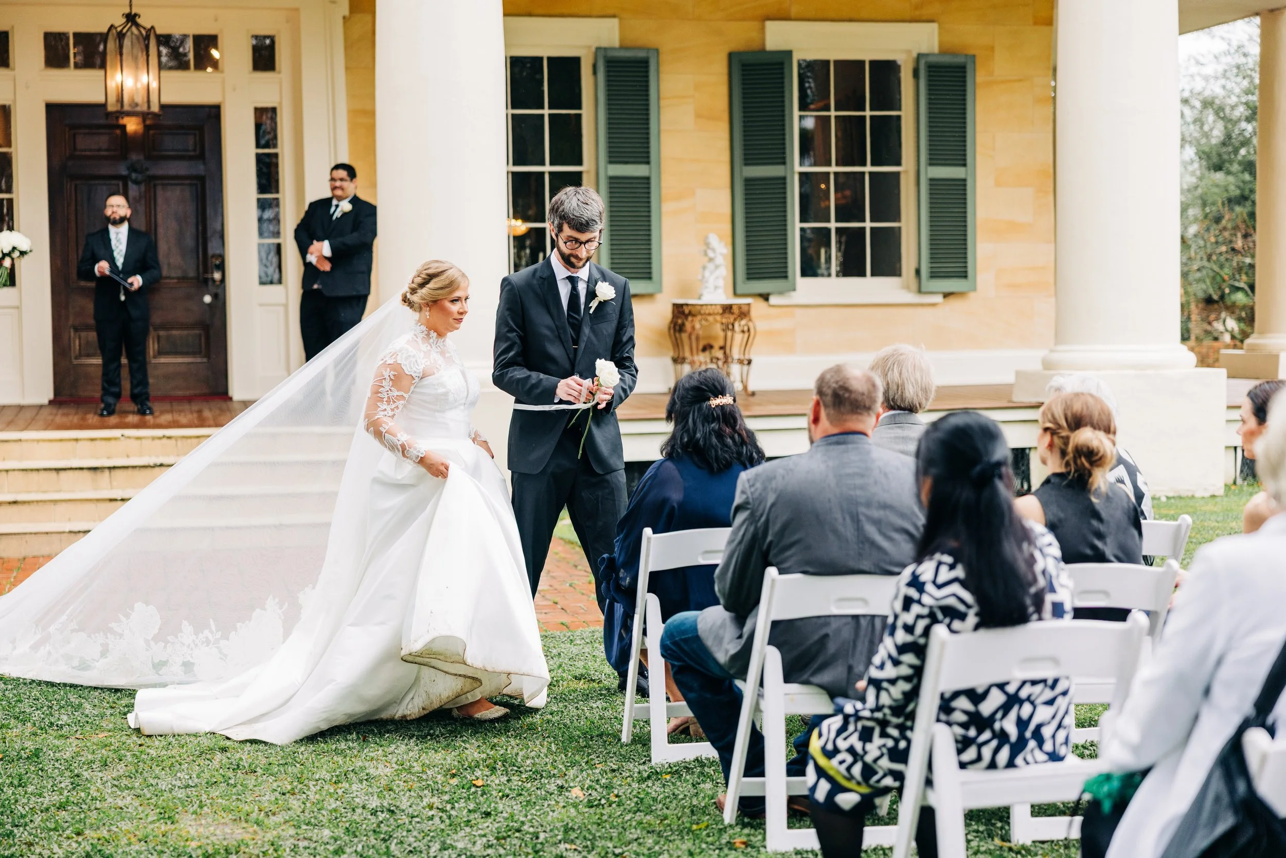 bride and groom giving mothers flowers at houmas house during outdoor wedding ceremony in spring, baton rouge wedding photography