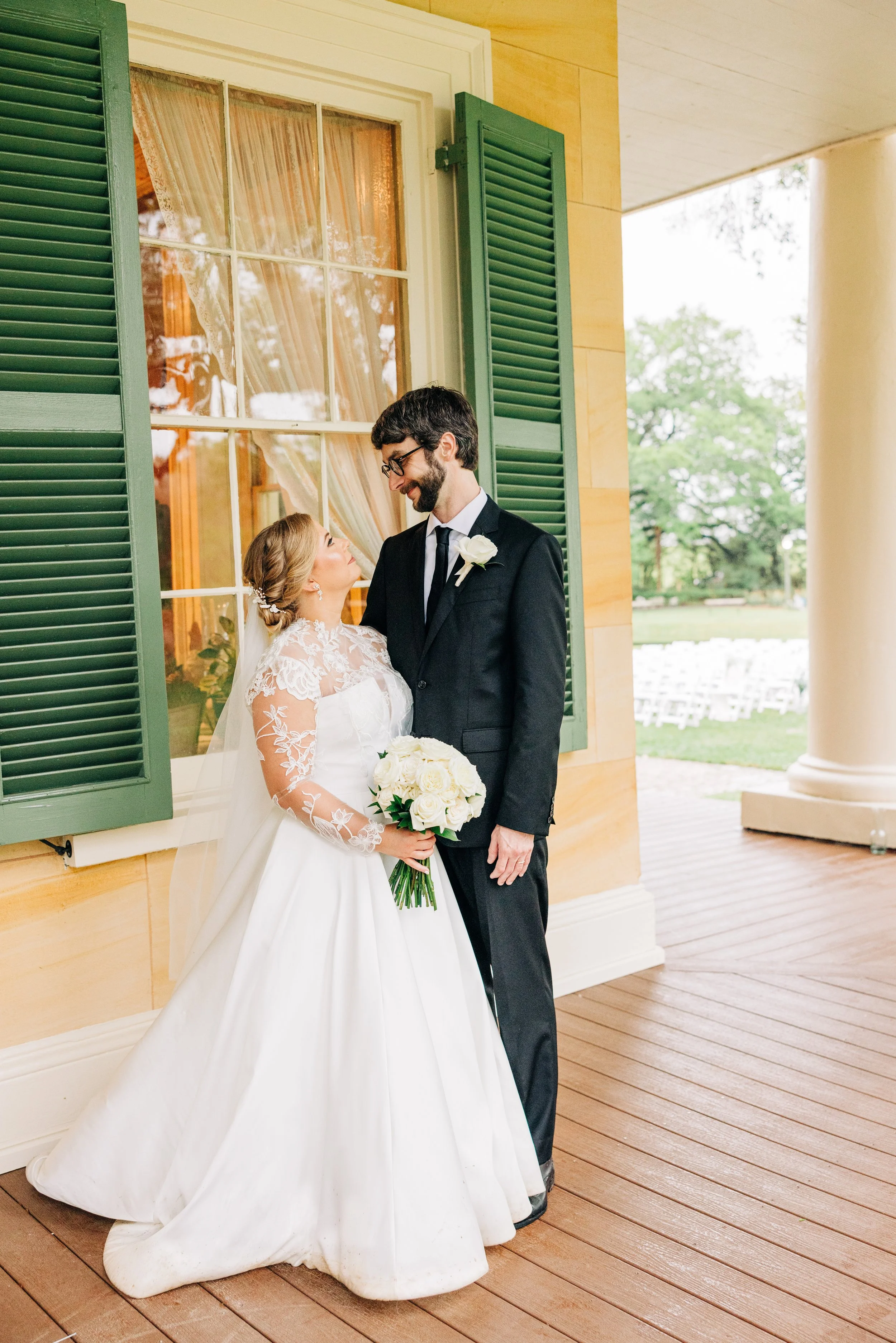 bride and groom portraits on the porch at houmas house baton rouge, bride and groom smile at each other, baton rouge wedding photography, sarah shaw photography