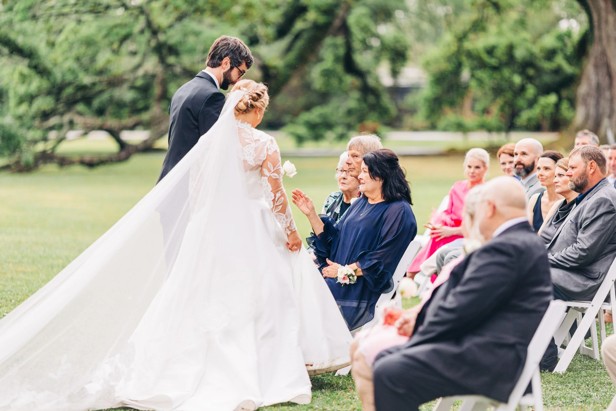 bride and groom giving mothers flowers at houmas house during outdoor wedding ceremony in spring, baton rouge wedding photography