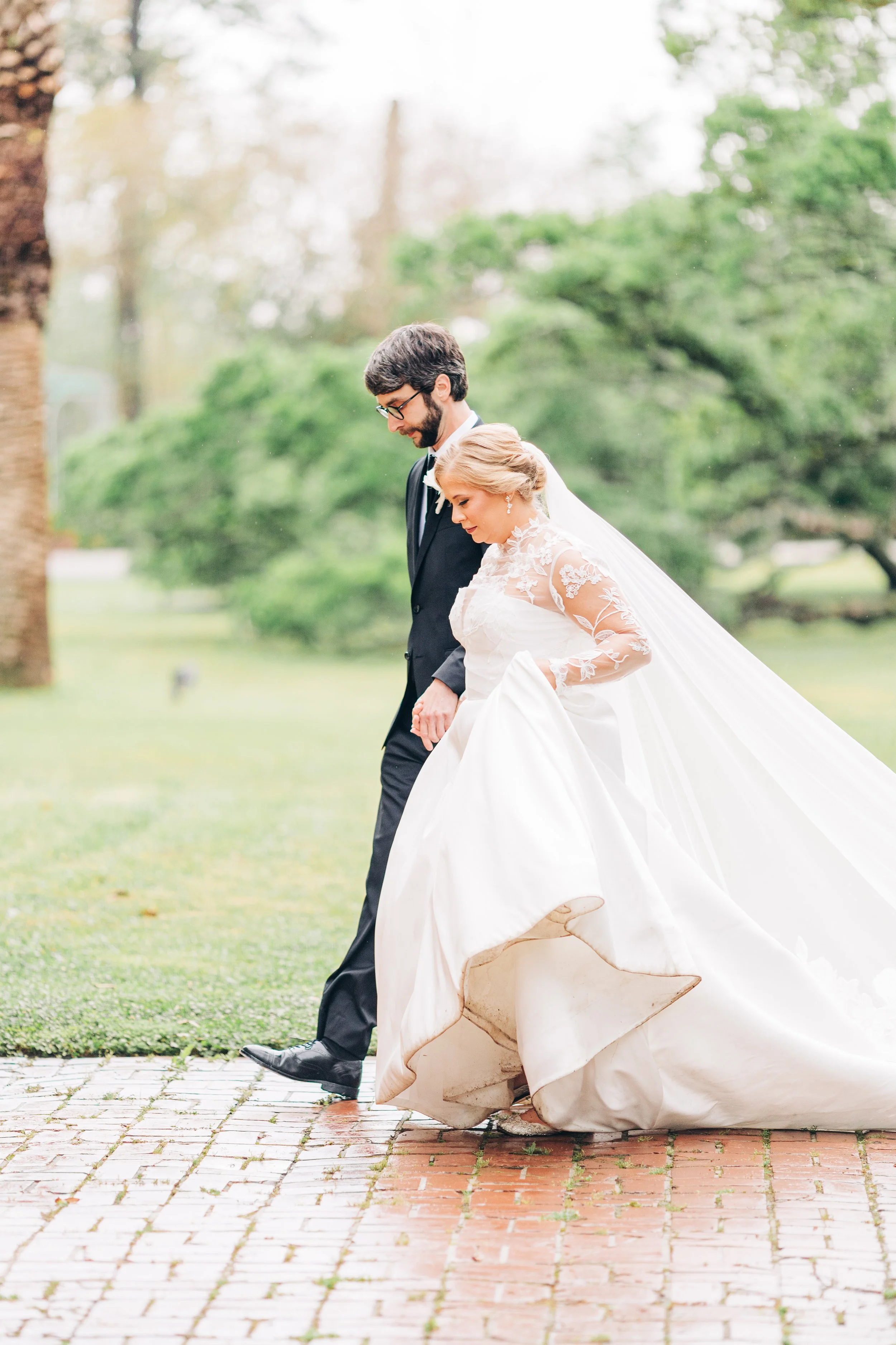 bride and groom walking hand in hand at houmas house during outdoor wedding ceremony in spring, baton rouge wedding photography