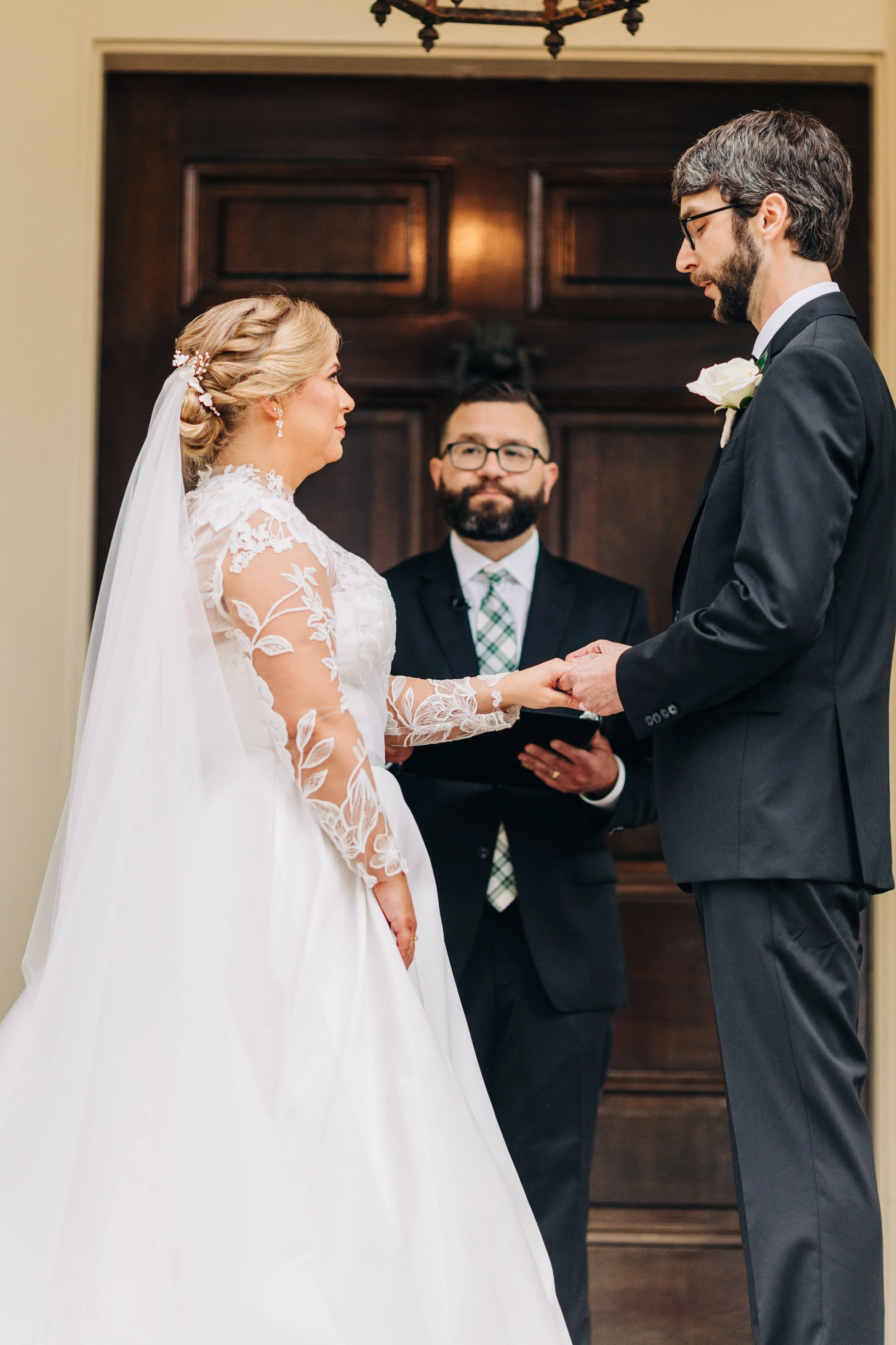 bride and groom on the front porch of houmas house during outdoor wedding ceremony in spring, exchanging vows, baton rouge wedding photography
