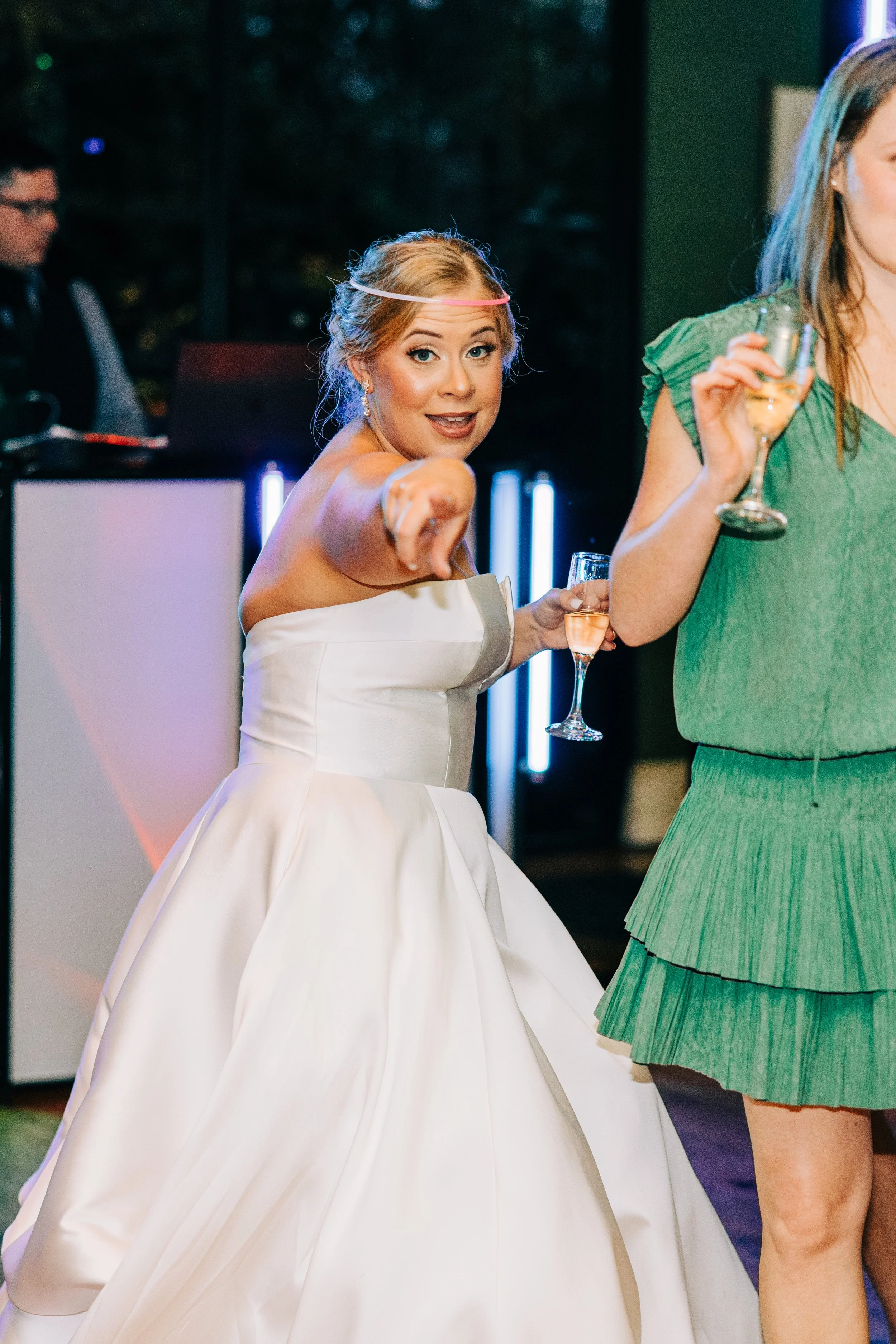 bride pointing at camera having fun at her wedding reception in the neptune at houmas house in baton rouge, baton rouge wedding photography