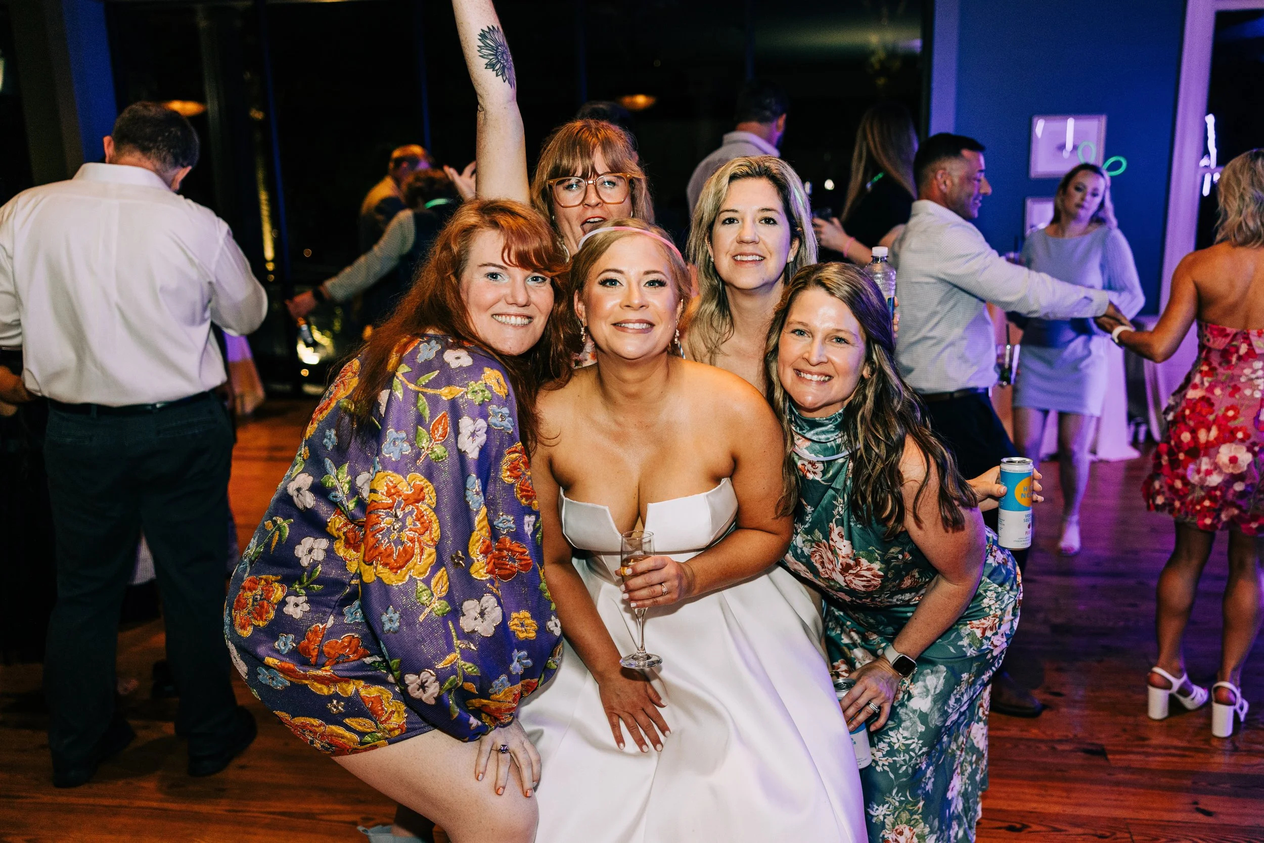 bride and her girlfriends pose together for a photo at the bride’s indoor wedding reception at the neptune at houmas house in baton rouge, baton rouge wedding photography