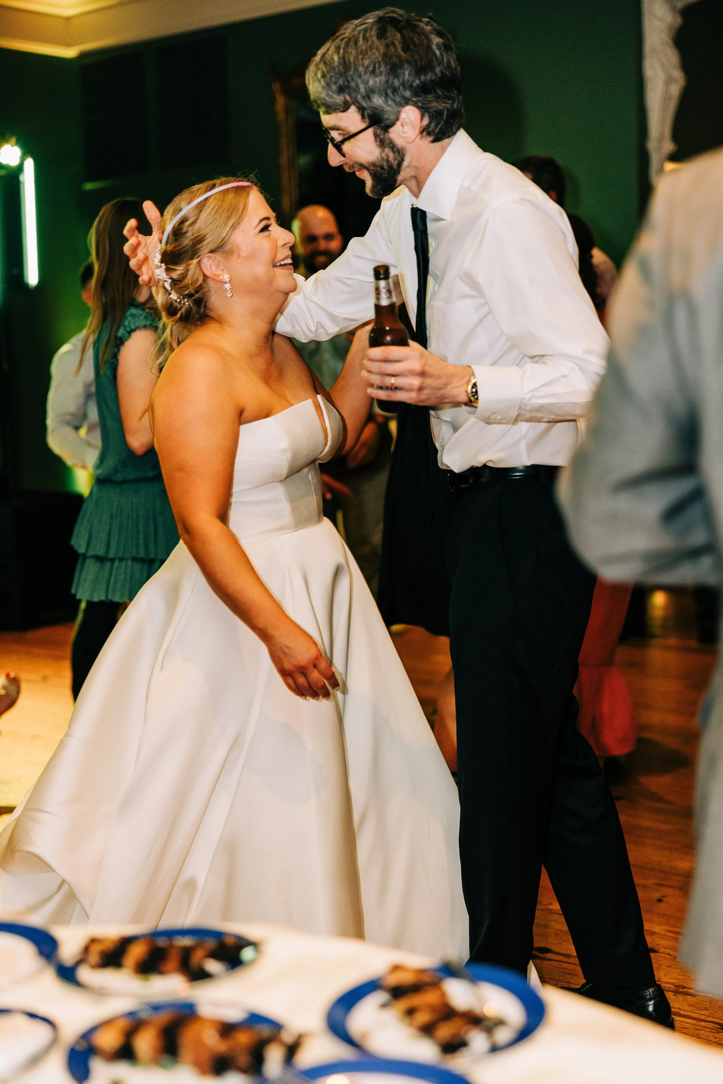 bride and groom smiling at each other having fun at their wedding reception in the neptune at houmas house in baton rouge, baton rouge wedding photography