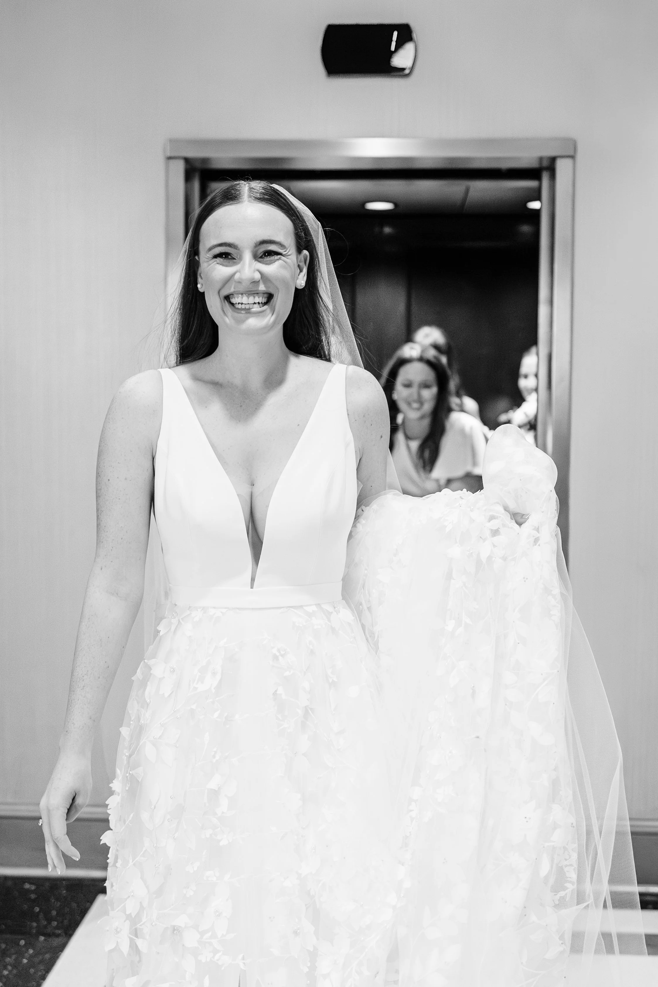 bride and bridesmaids exit elevator leaving bridal suite at baton rouge wedding