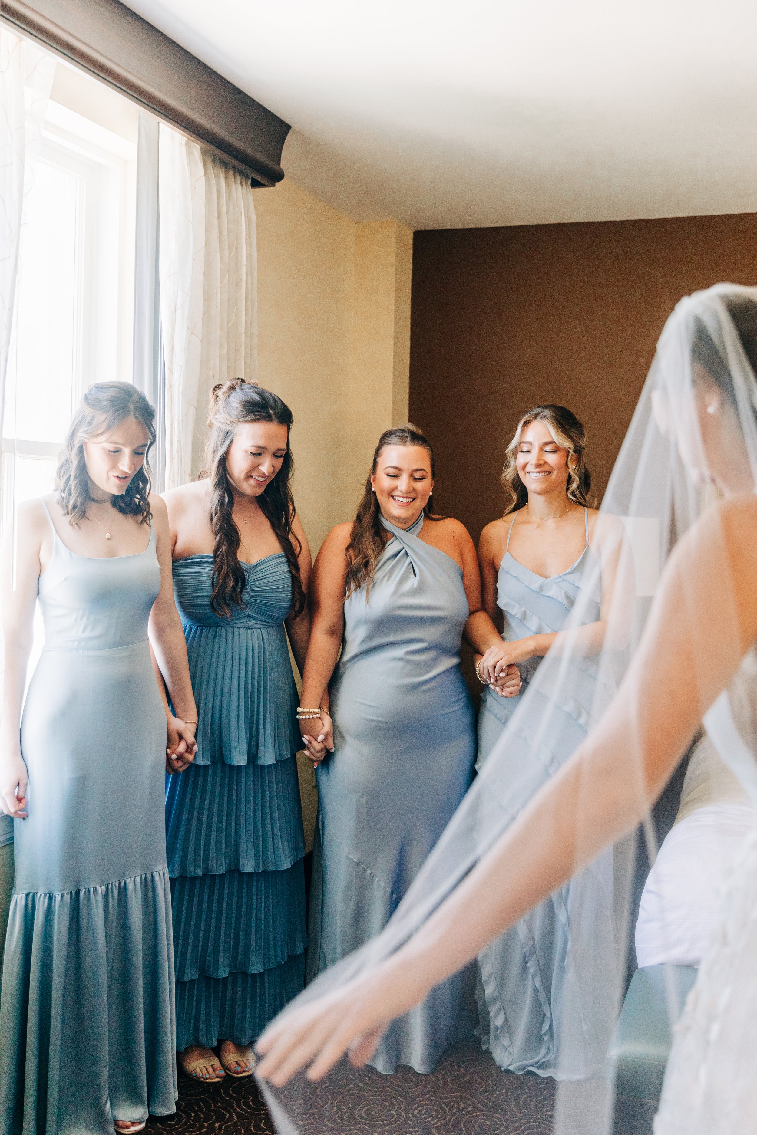 bridesmaids react to bride’s dress at wedding in baton rouge