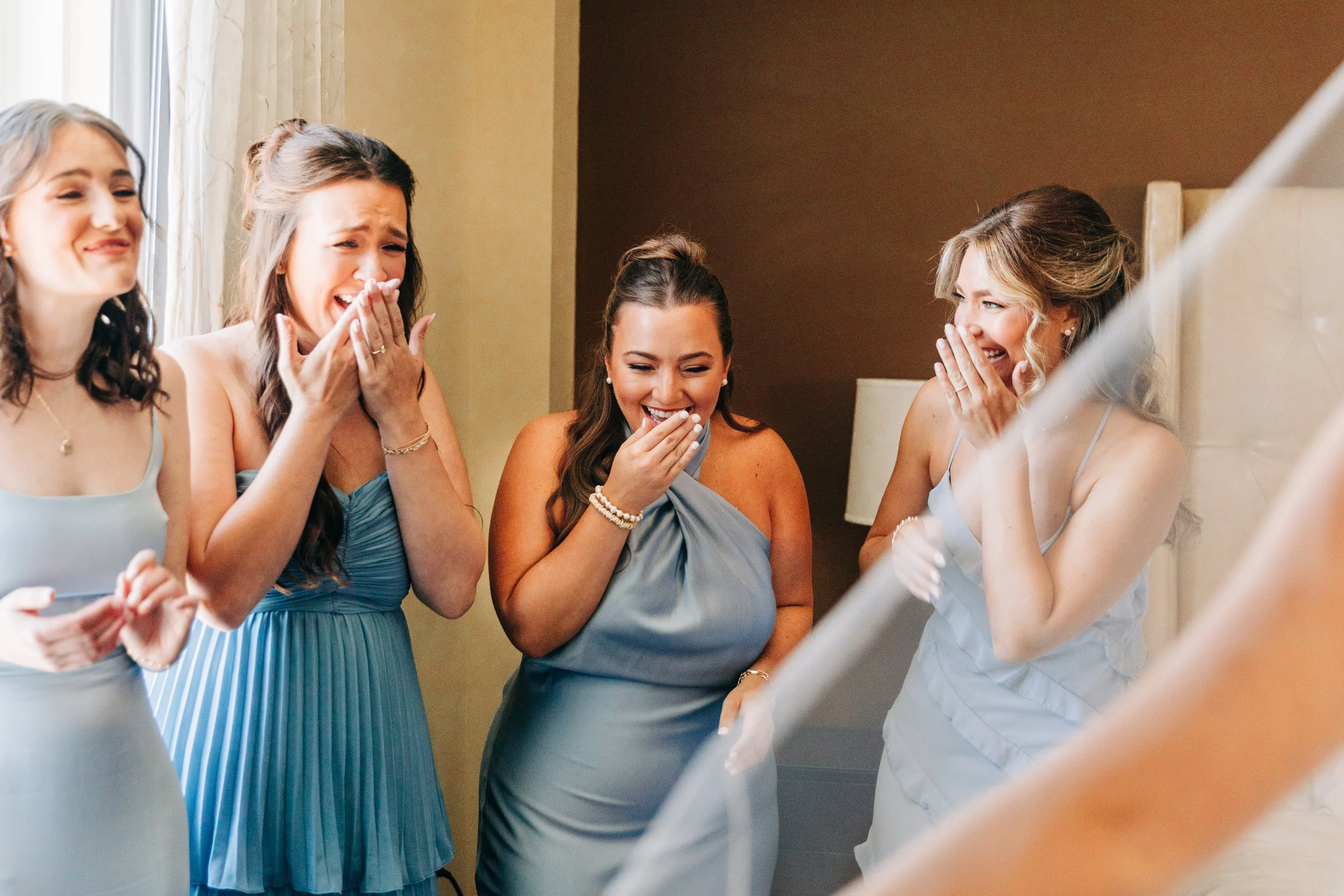 bridesmaids react to bride’s dress at wedding in baton rouge