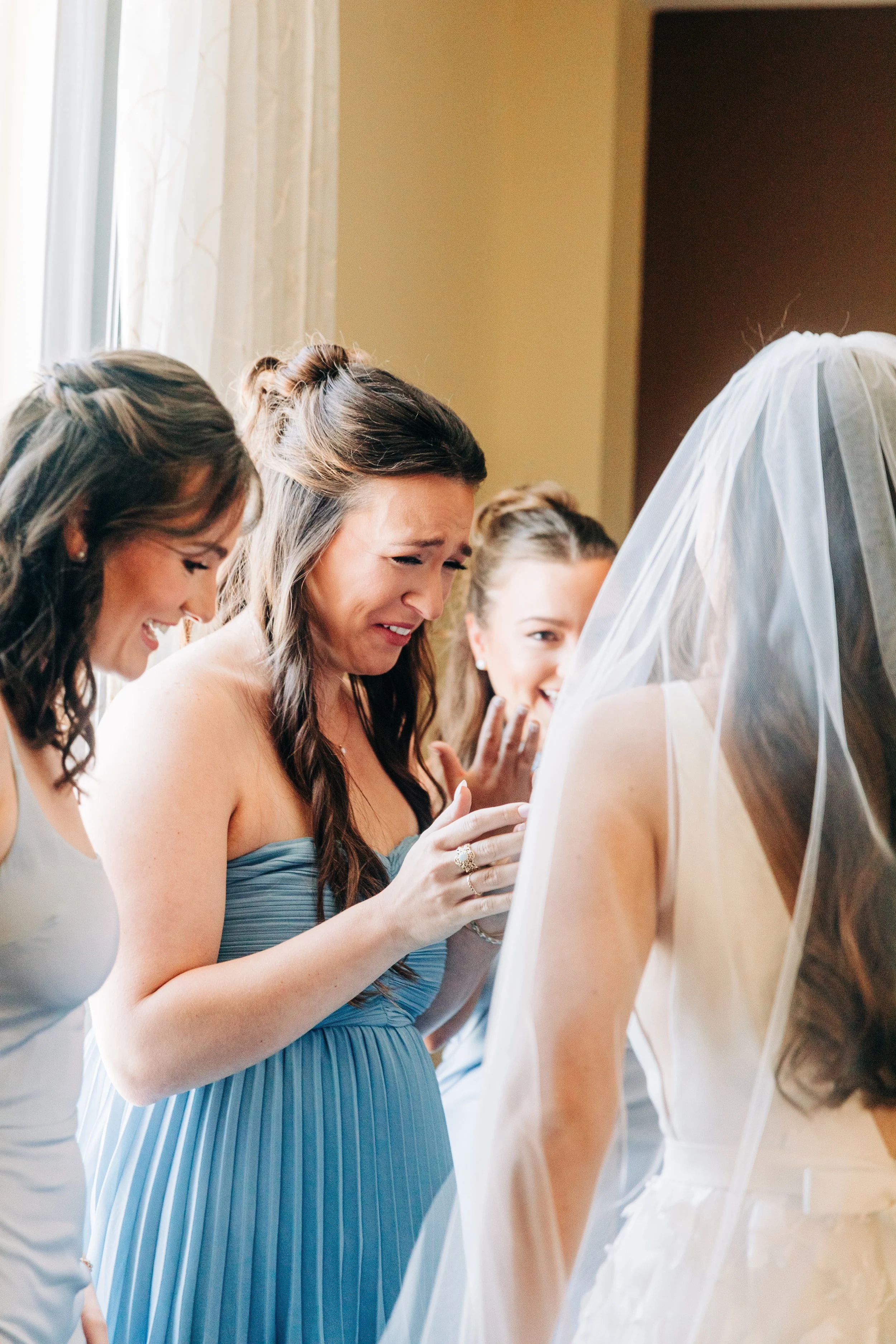 bridesmaids react to bride’s dress at wedding in baton rouge