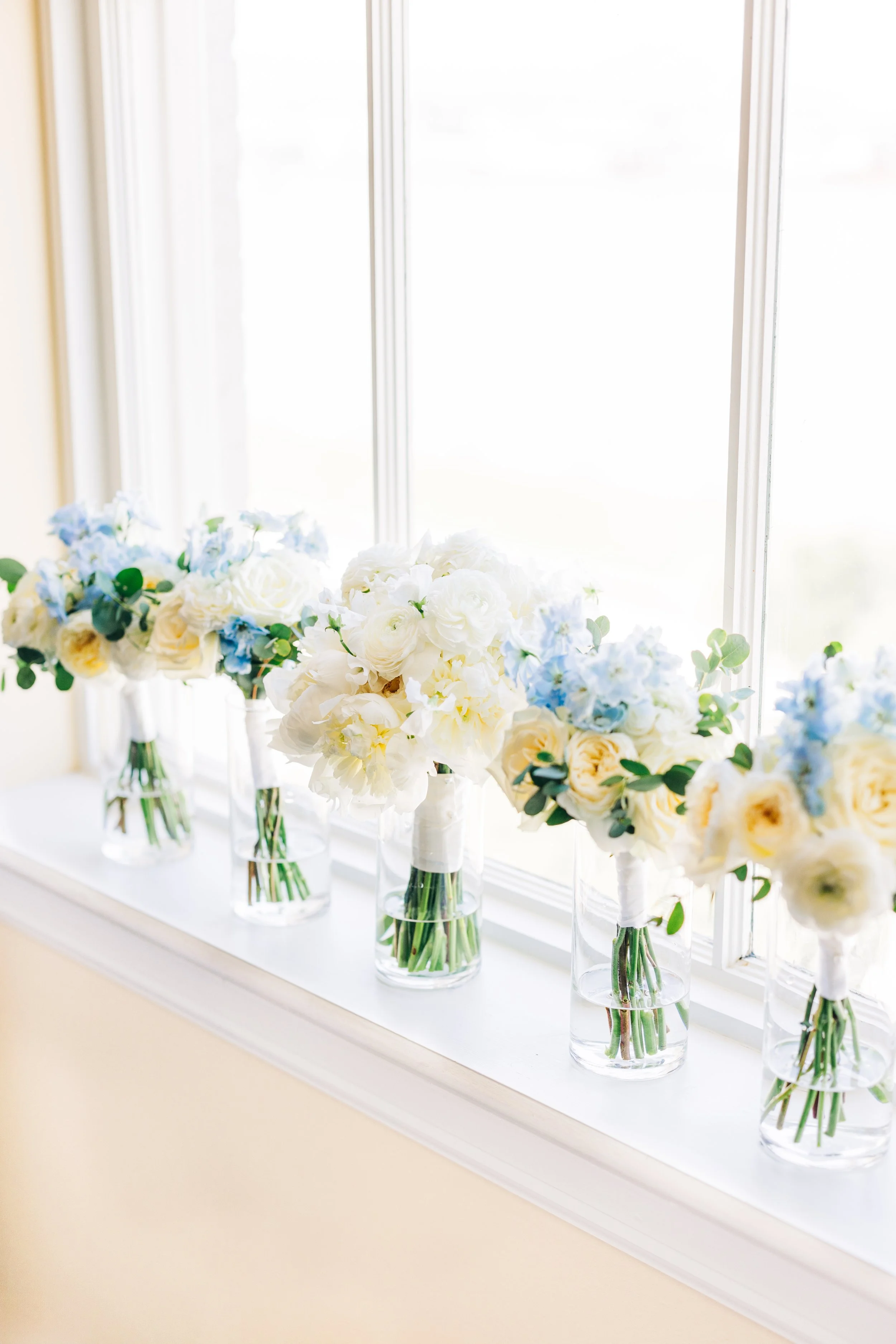 Bride and bridesmaids bouquets in window at baton rouge wedding
