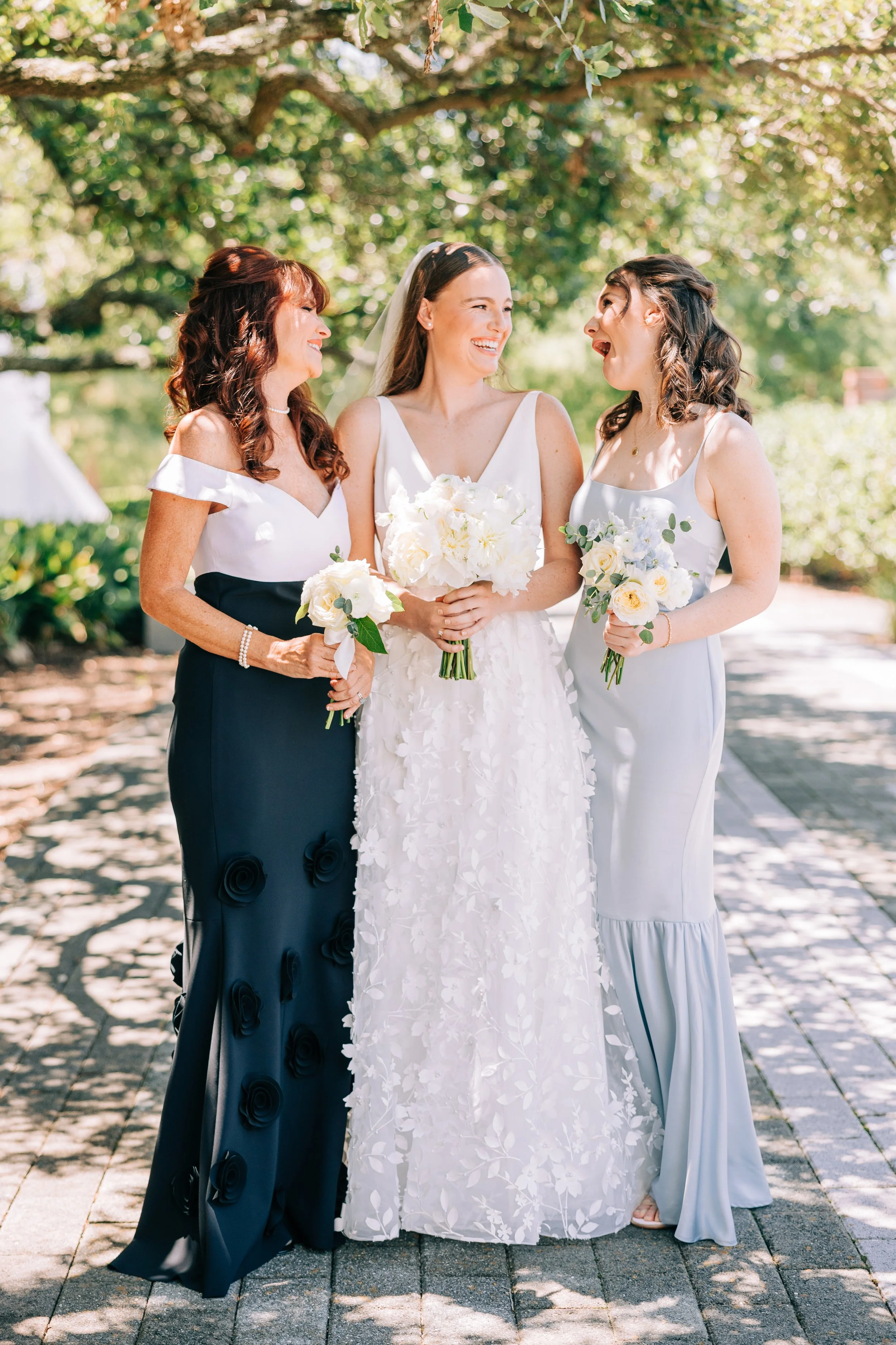 bride mother and sister laughing together at baton rouge wedding