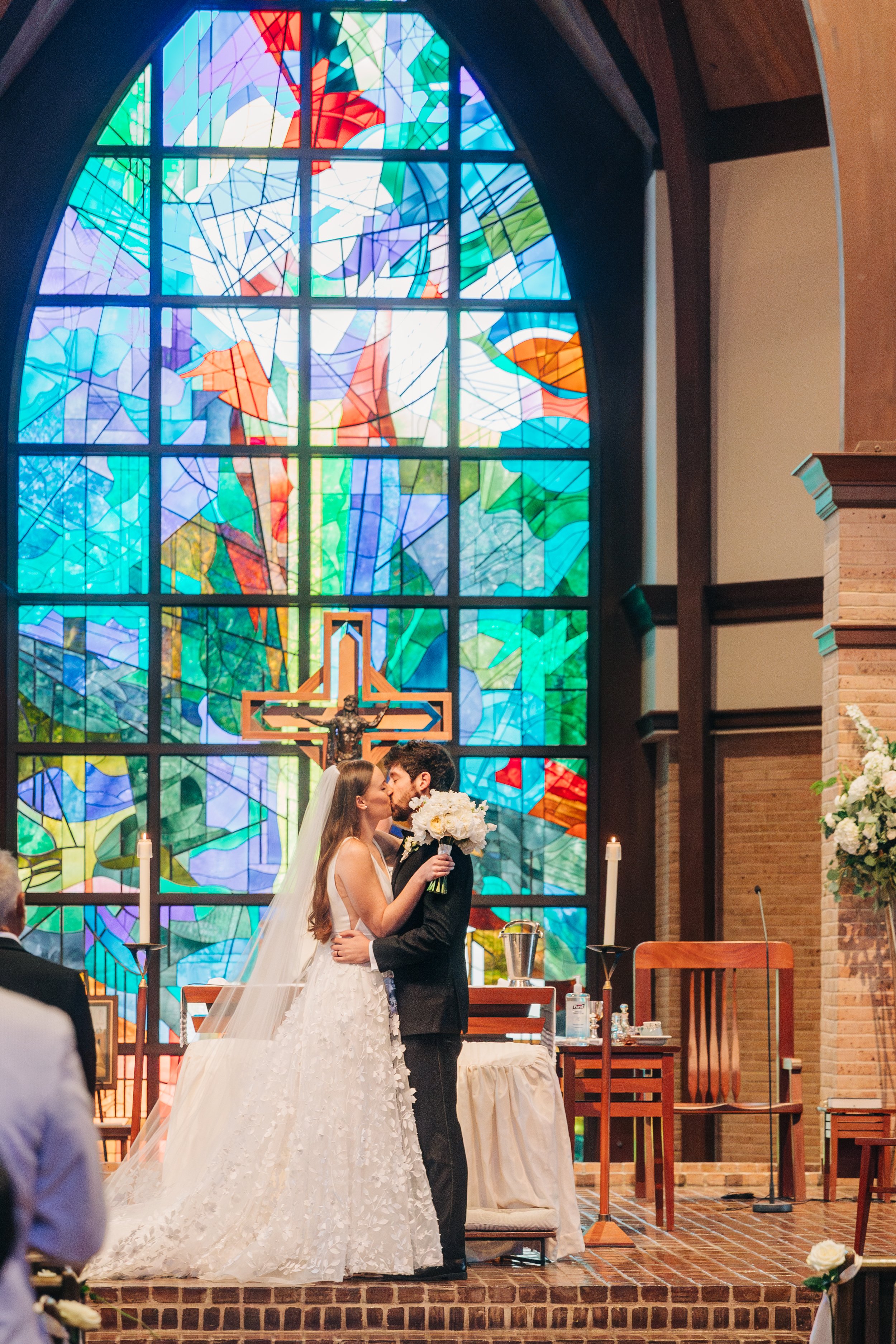 bride and groom kiss at altar during baton rouge wedding