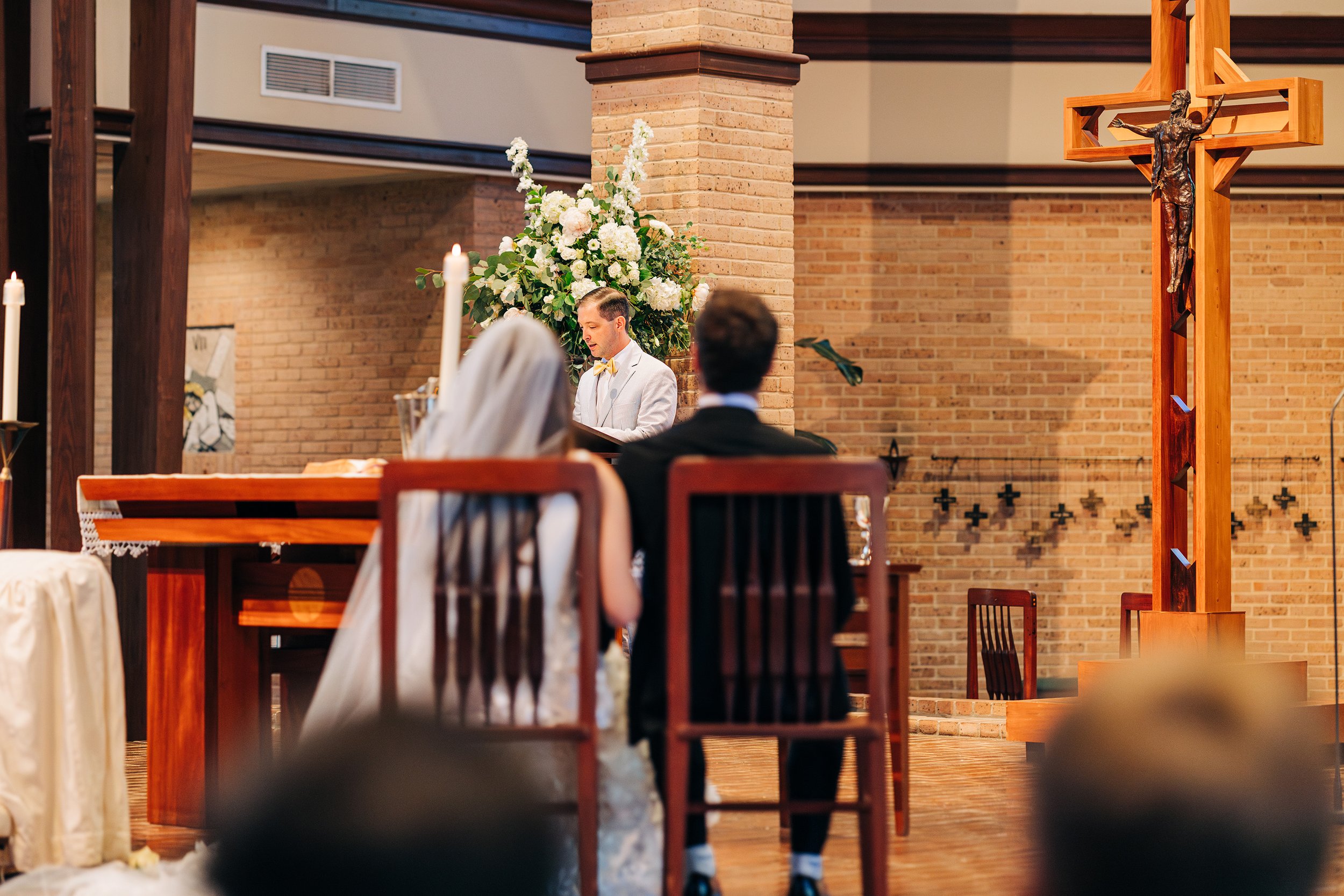 bride and groom seated during baton rouge wedding ceremony