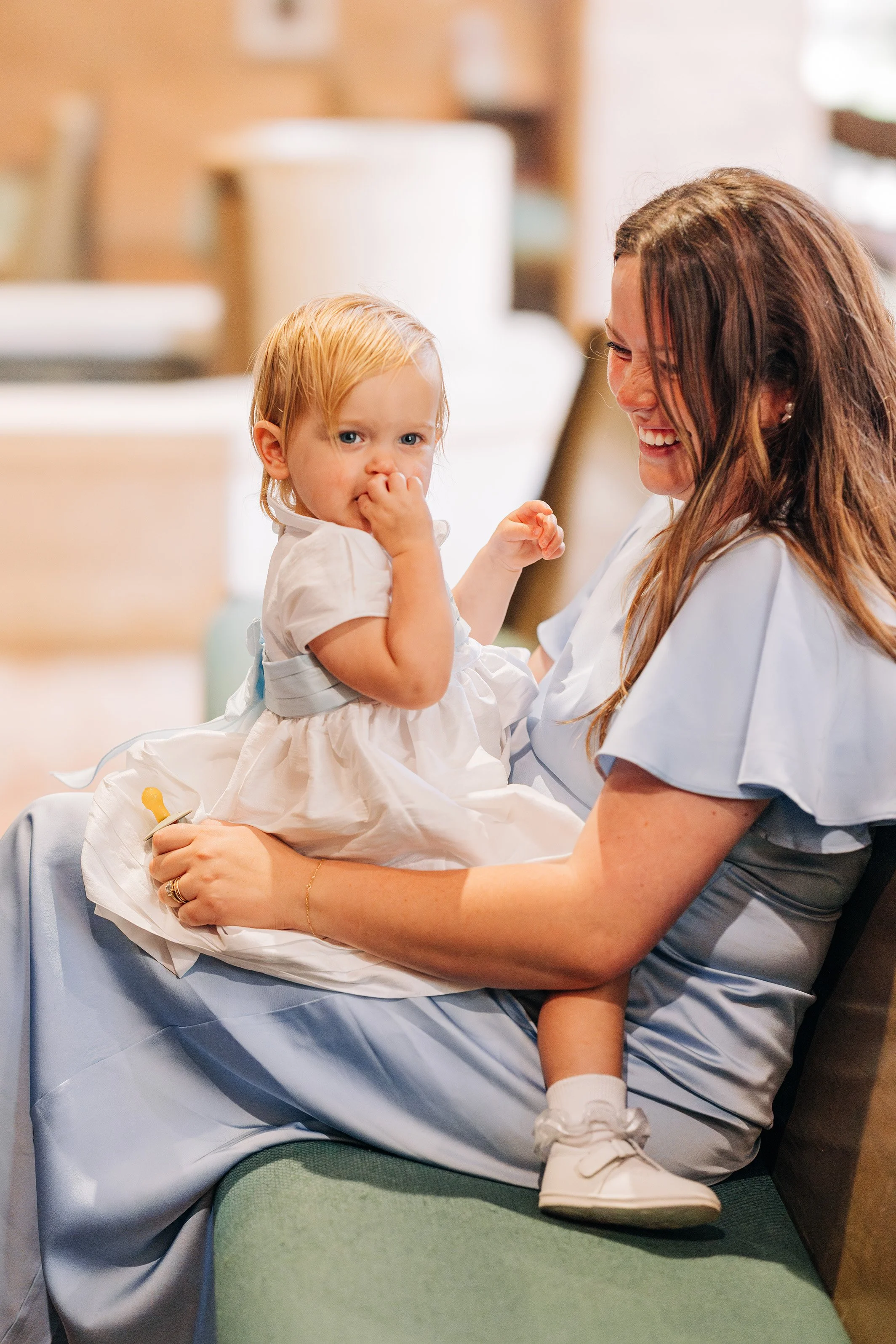 mother holding baby during baton rouge wedding