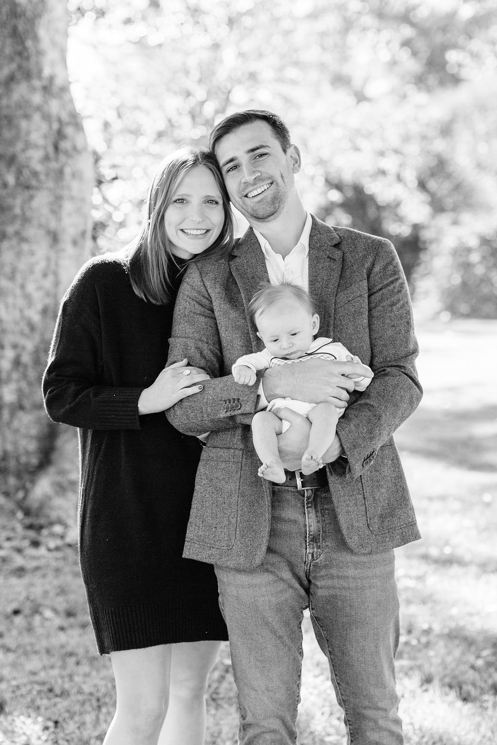 mom standing with dad holding newborn baby during family portrait session in baton rouge
