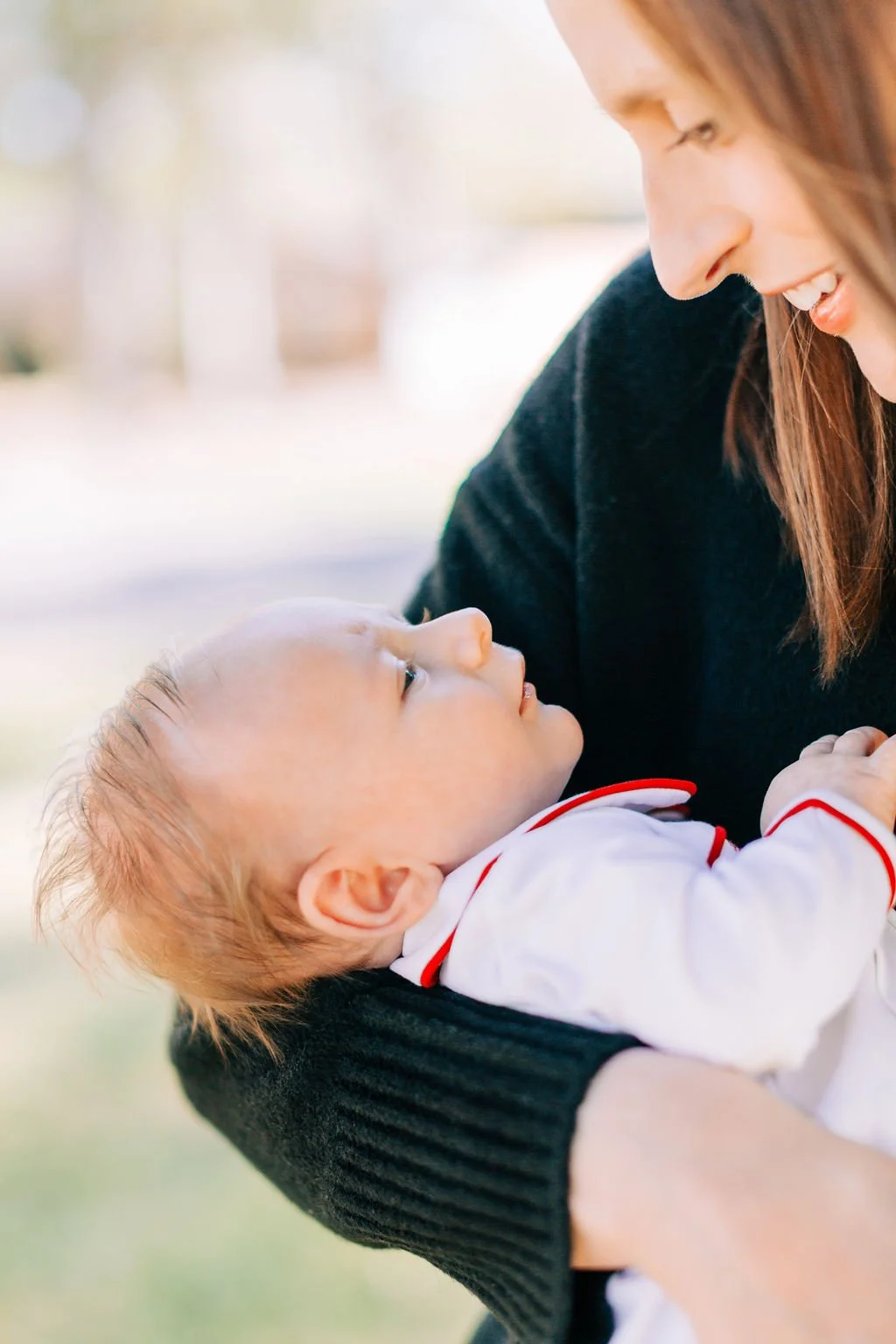 close-up of newborn baby being held by his mom during family portrait session in baton rouge